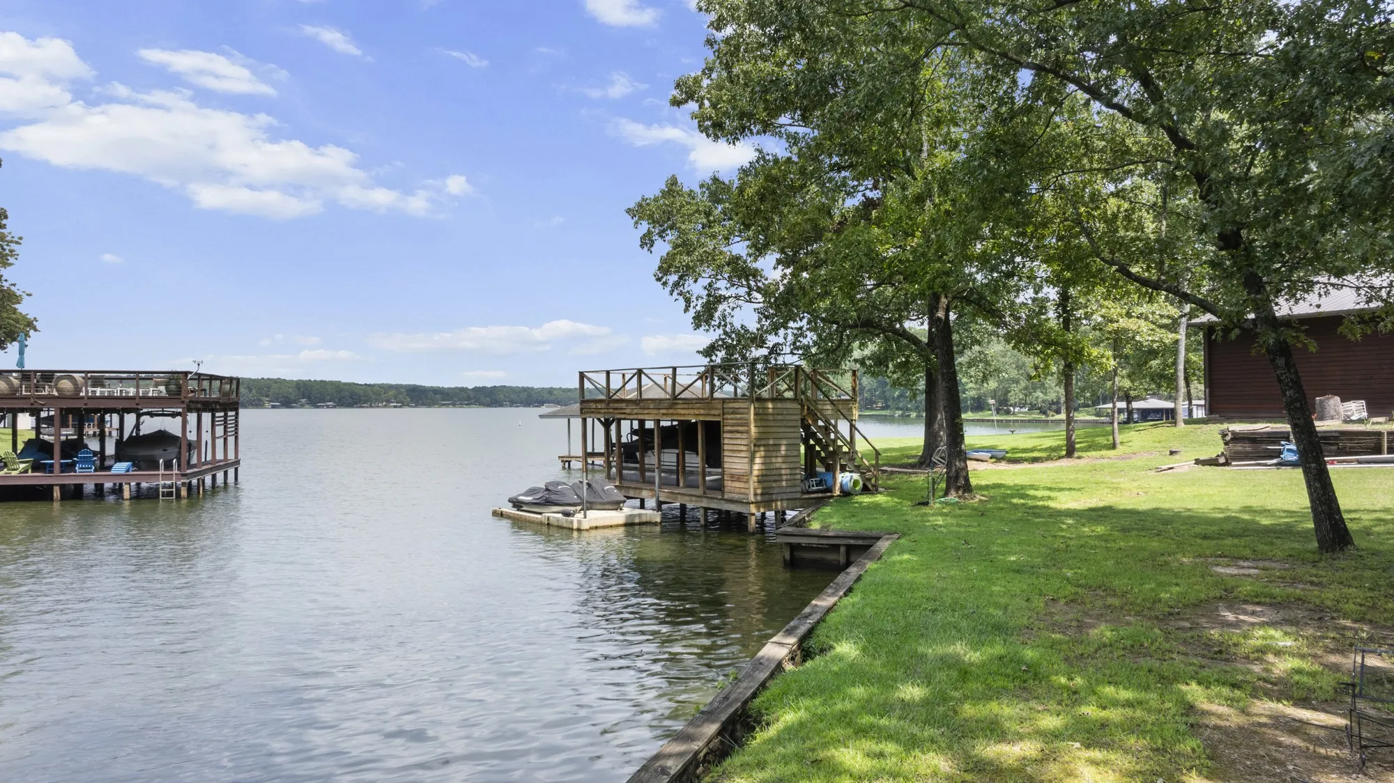 Dock featuring a water view and a lawn