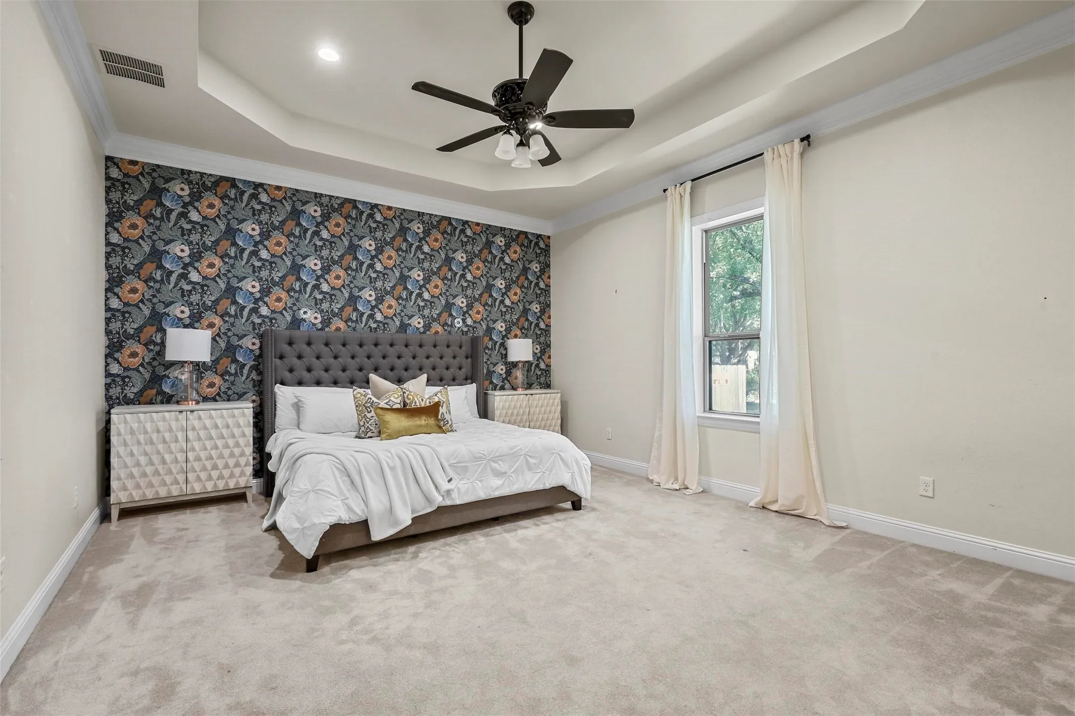 Tray ceiling featuring a ceiling fan with integrated lighting