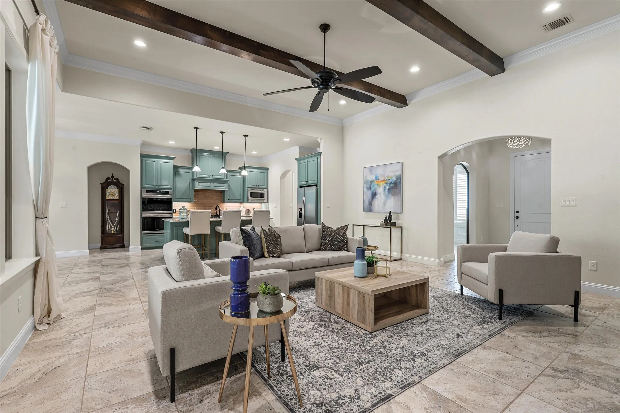 High ceilings with exposed wood beams, recessed lighting, and a ceiling fan
