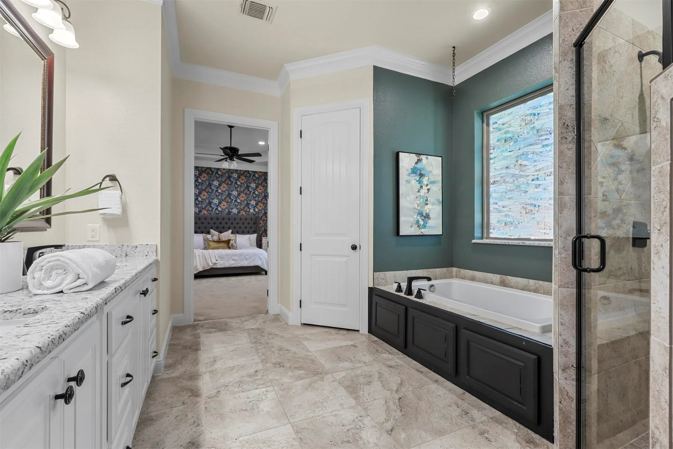 Dual sink vanity with stone countertop, tile flooring, built-in soaking tub, and glass-enclosed shower