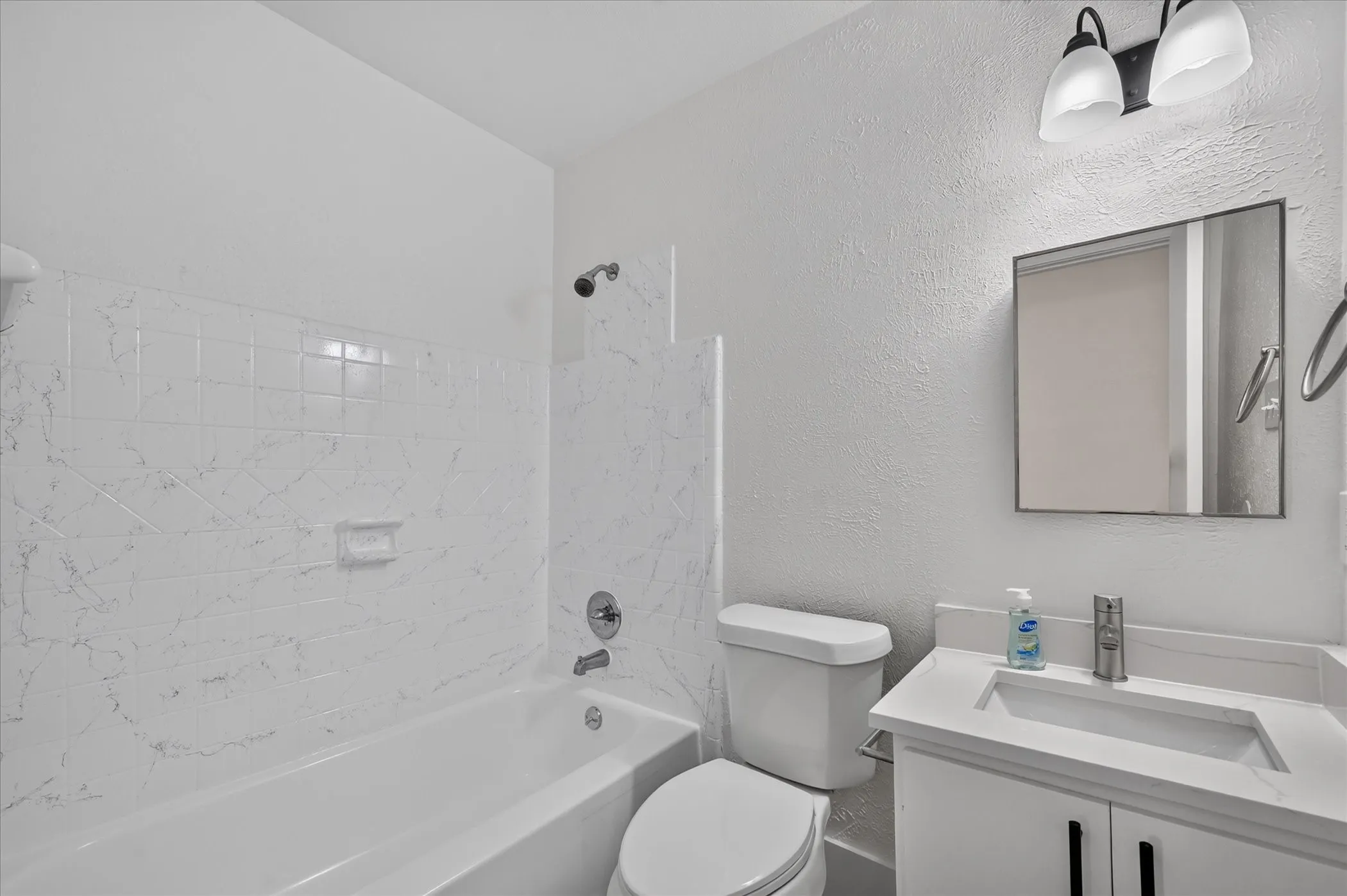 White tiled shower and tub combination