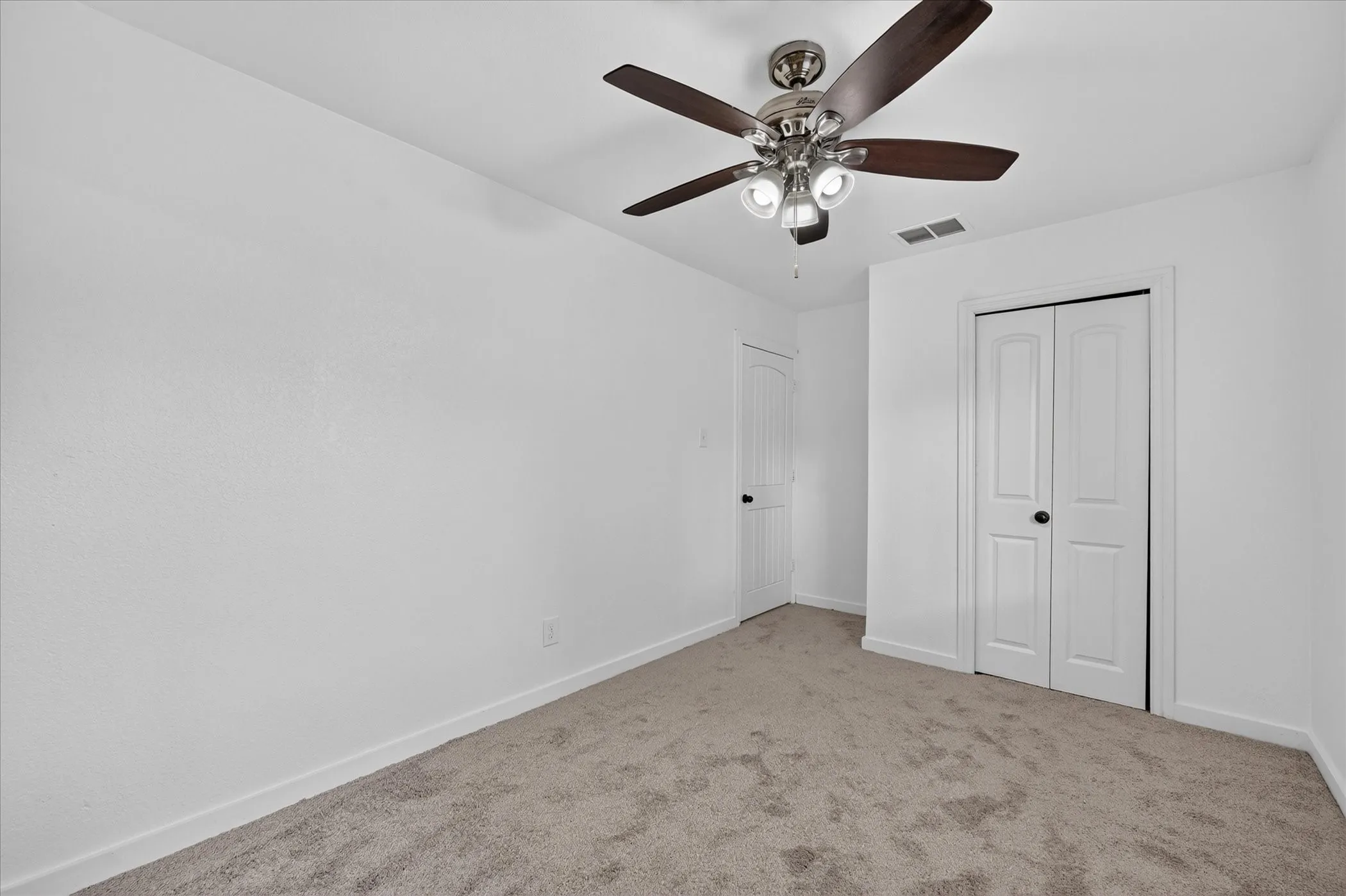 Neutral-toned carpeting and bright white walls
