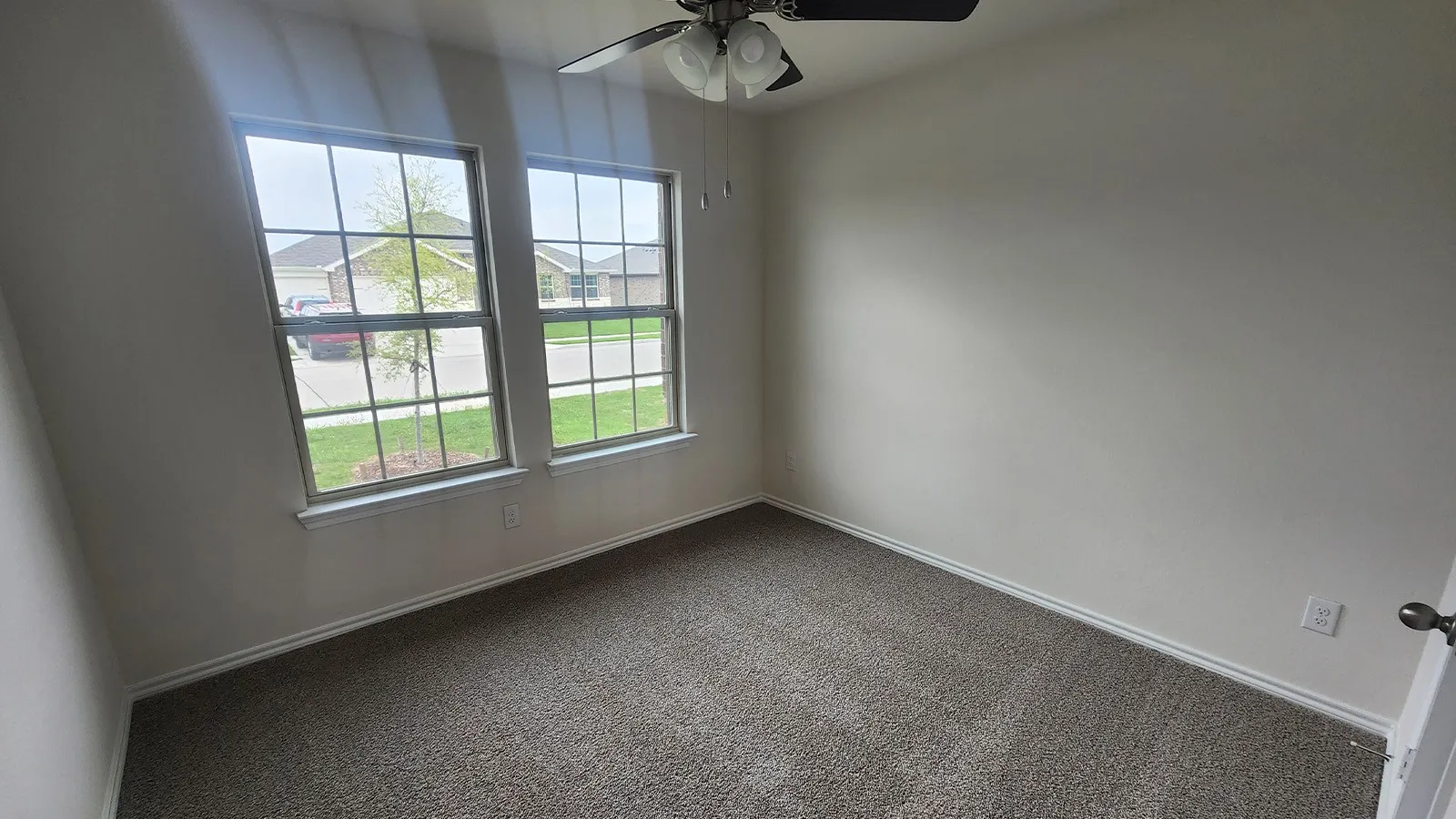 Recessed windows, neutral wall tones, and textured carpeting