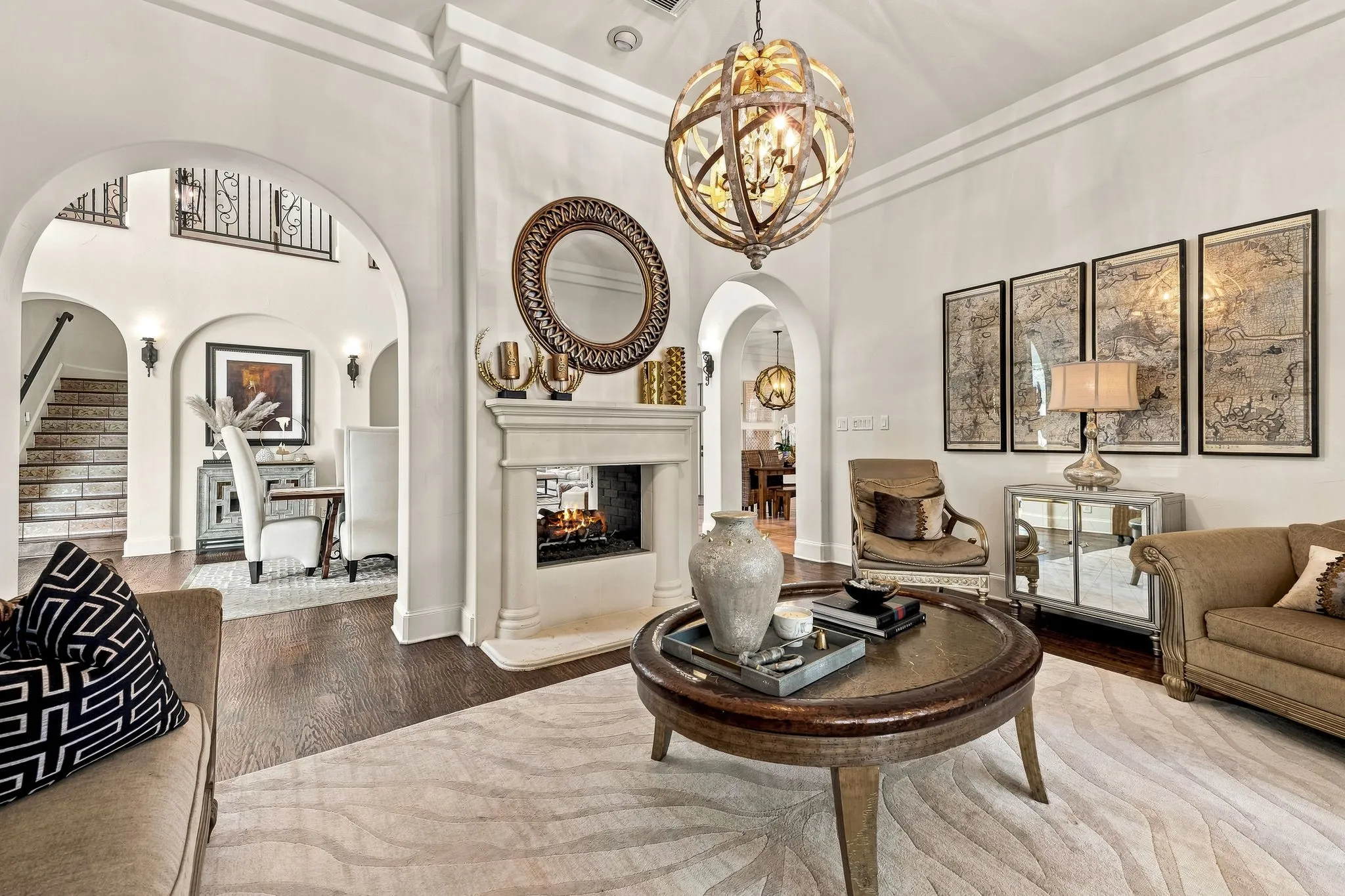 Archways, dark wood-finish flooring, fireplace, decorative lighting, and crown molding