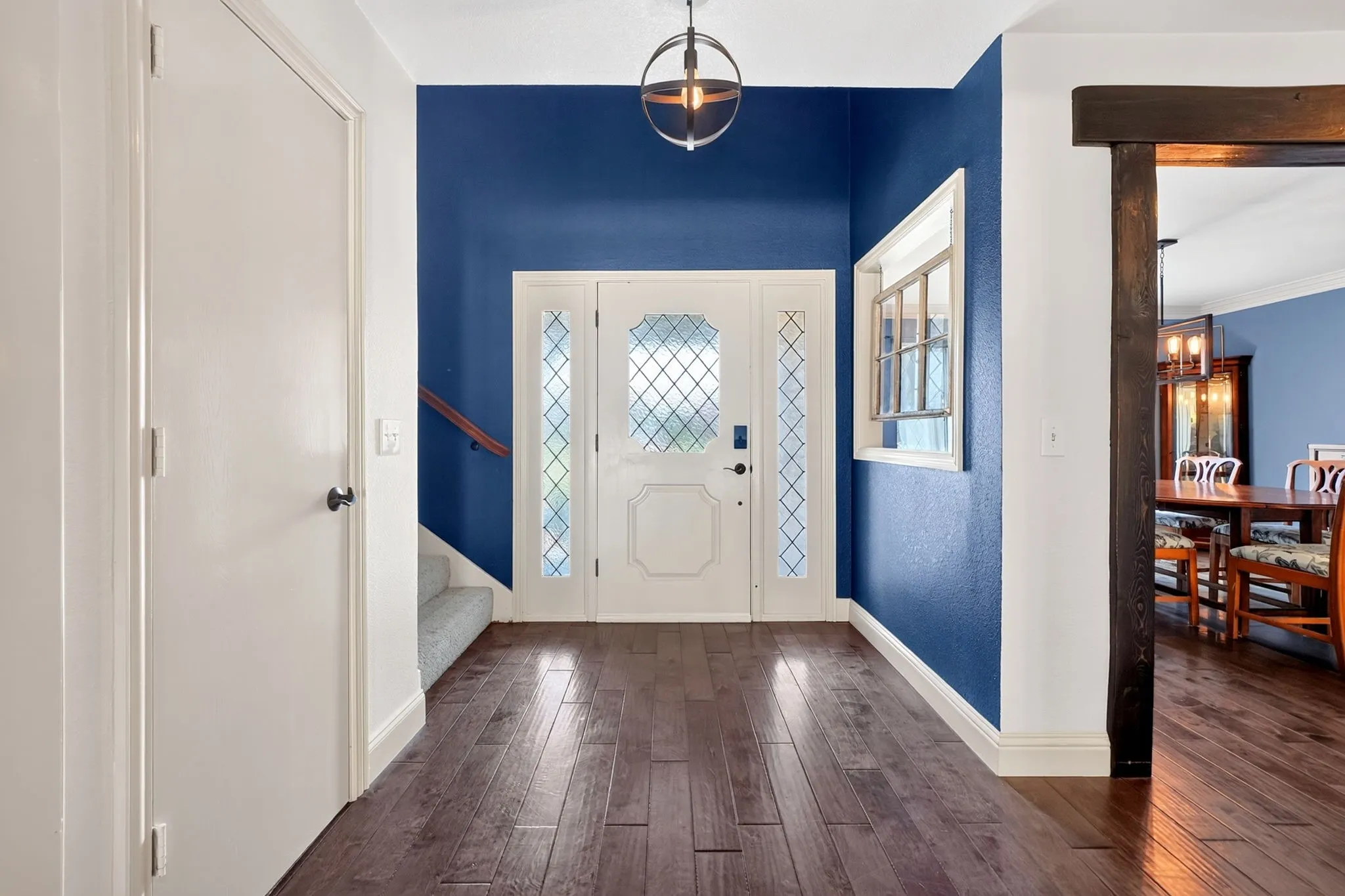 Entryway with wood flooring and staircase
