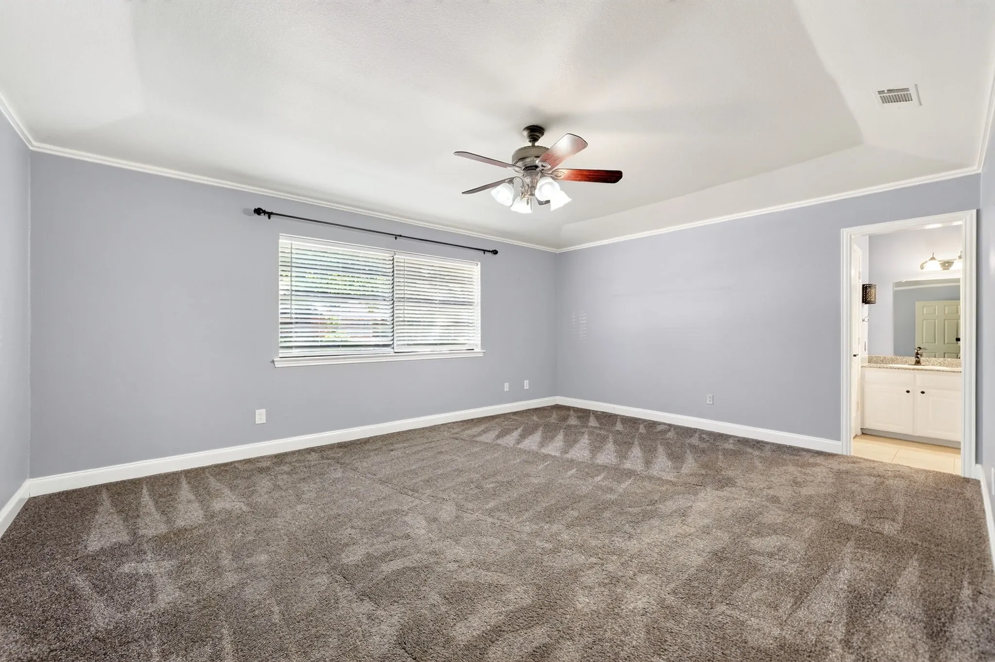 Primary bedroom with backyard views