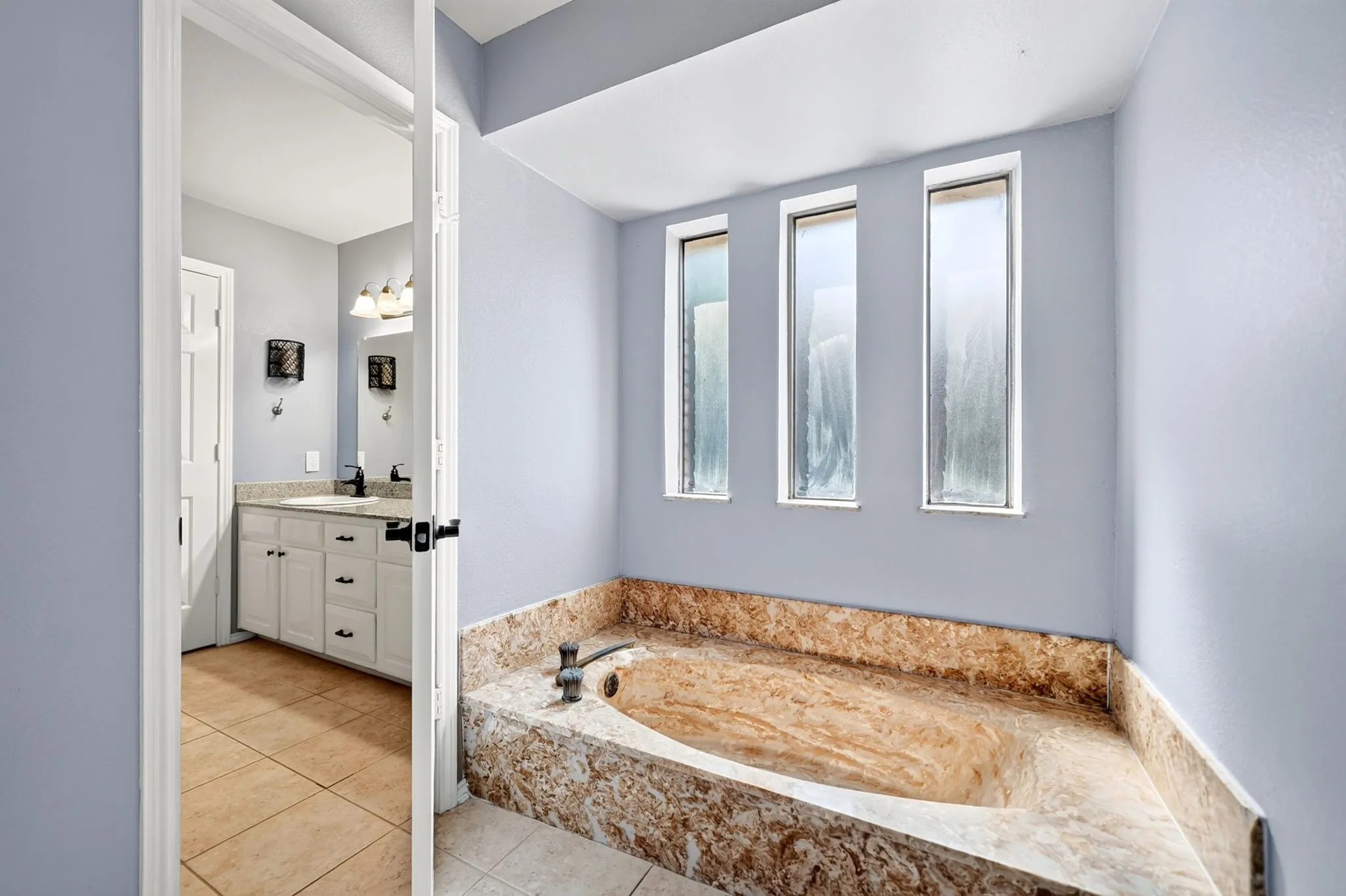 Stone soaking tub with natural light
