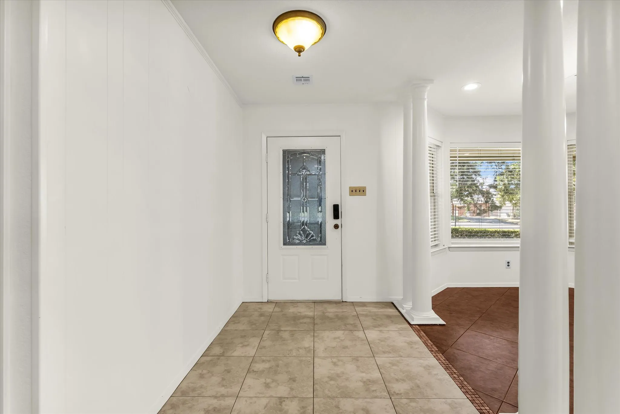 Entryway featuring decorative leaded glass front door, ceramic tile flooring, and a flush mount ceiling light