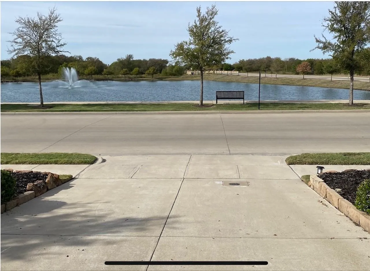 Standing in the driveway looking at the pond across the street.