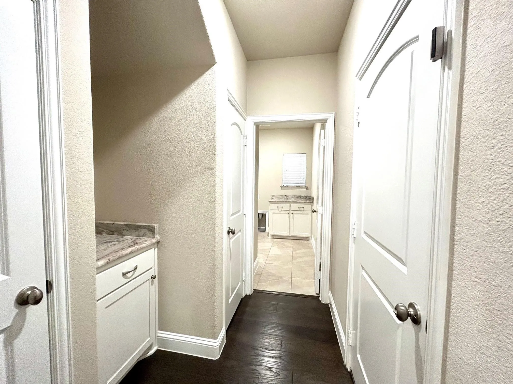 This view is the hallway leading to the garage on the right side and straight back is the large utility room.  The closet door on the left is a storage closet.