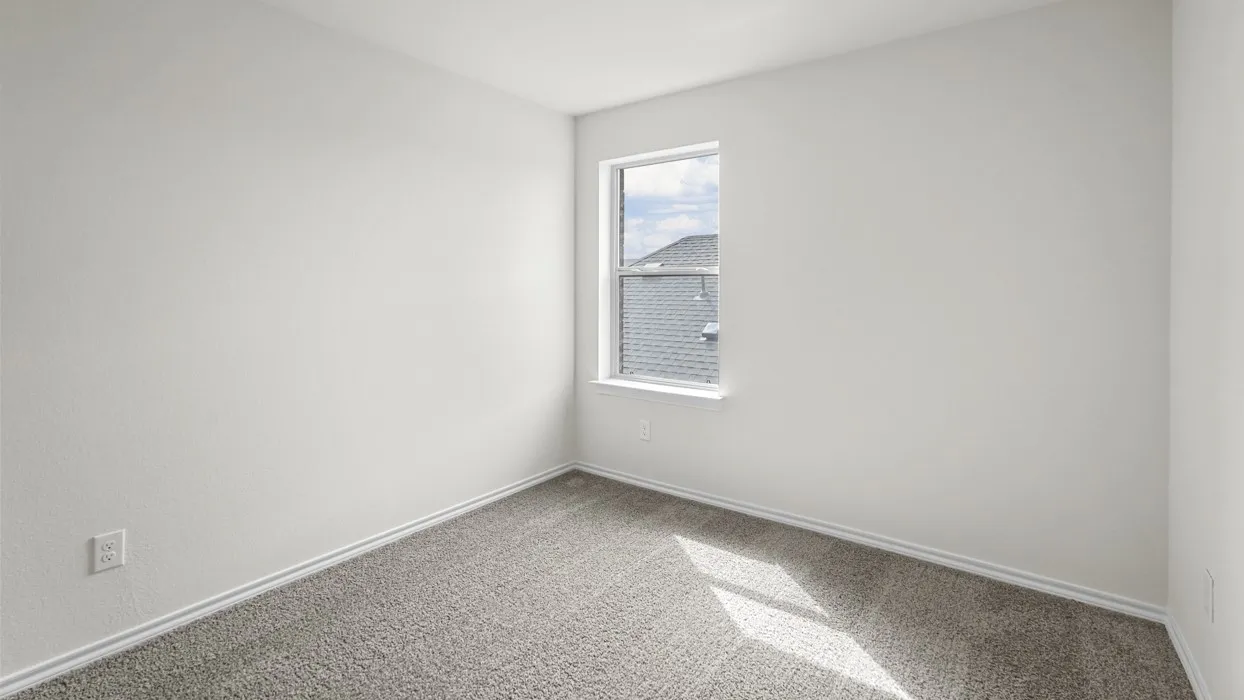 Neutral-toned interior room featuring a single window and plush carpeting
