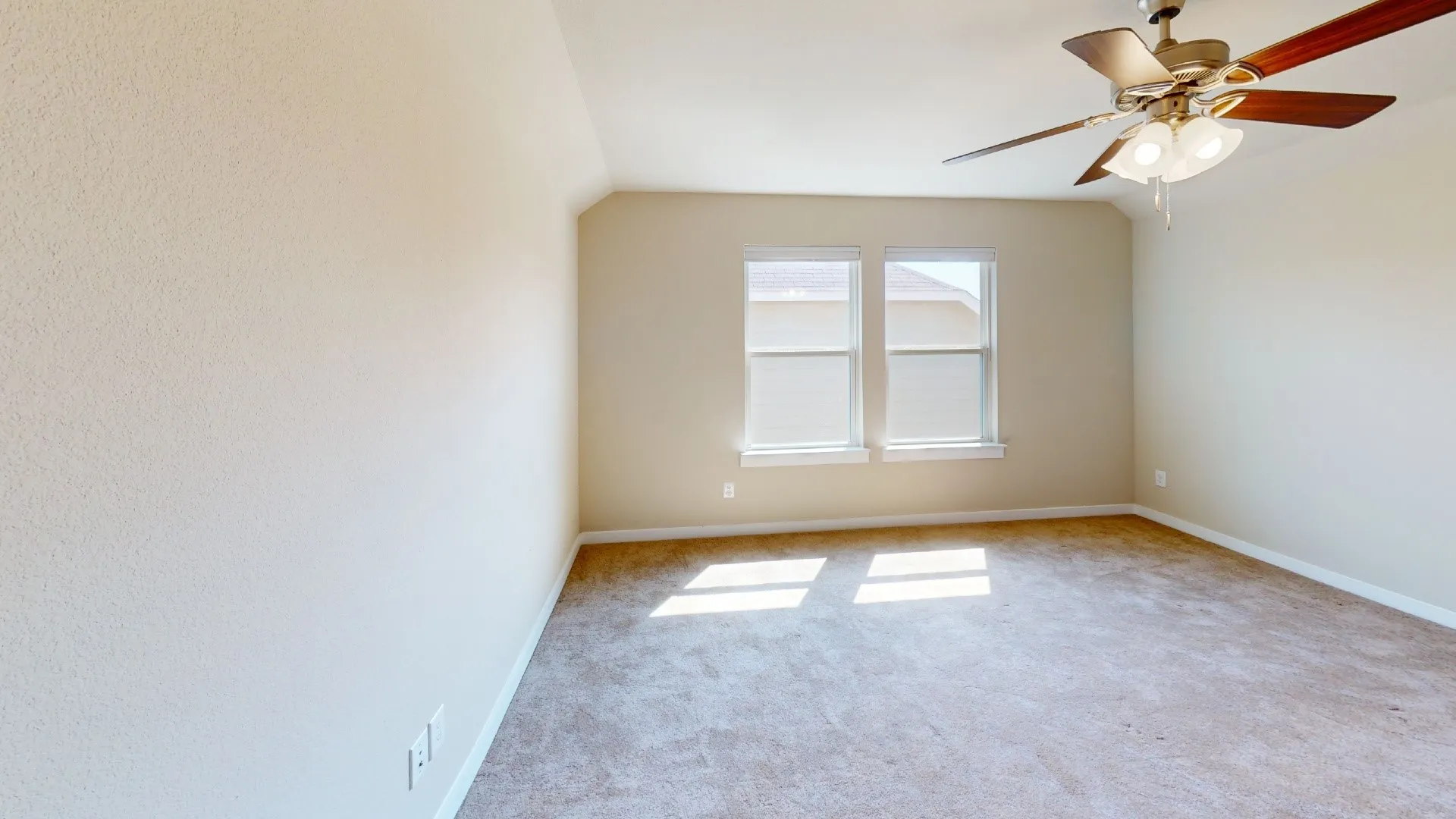 Tray ceiling, ceiling fan with light fixture, two windows, neutral wall color, and carpeted flooring
