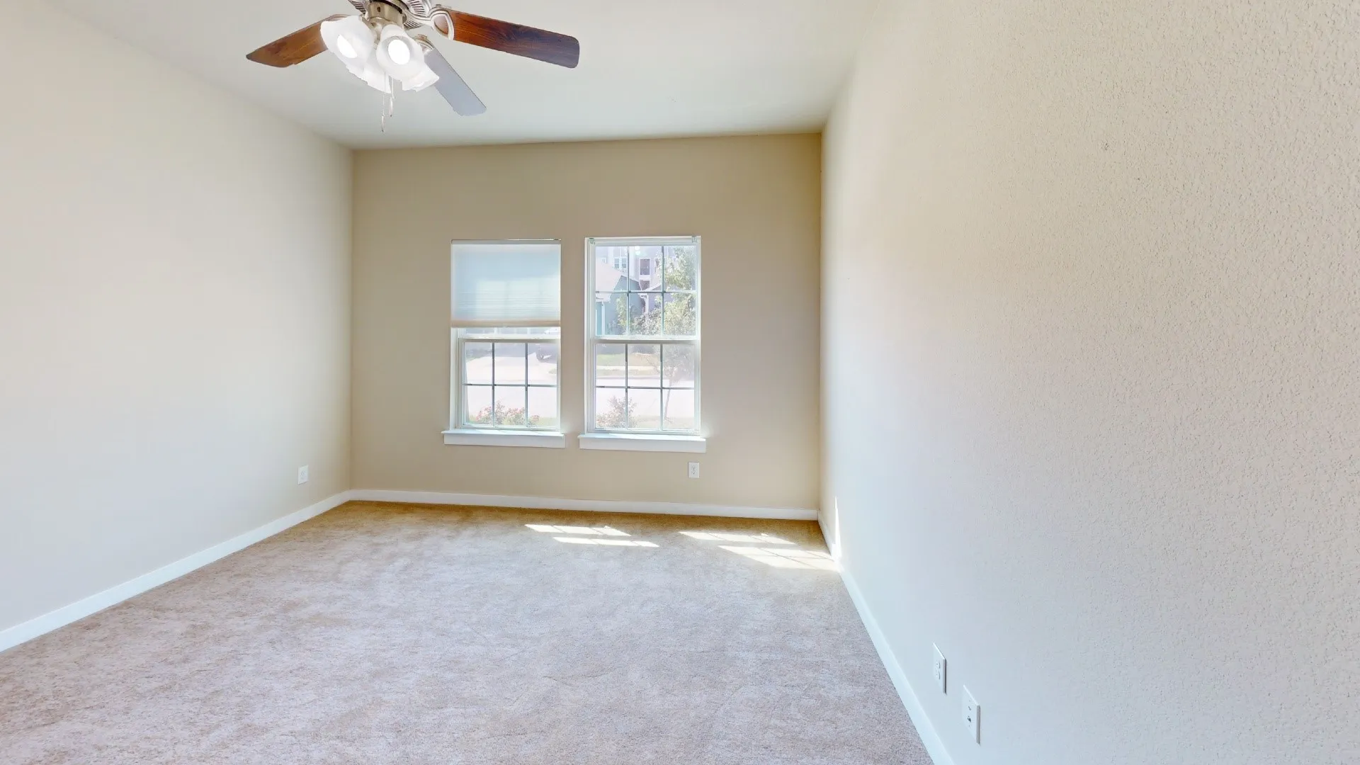 Neutral-toned walls complement the carpeted flooring