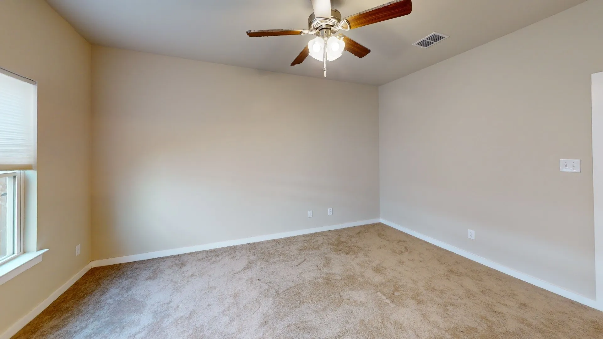 Vaulted ceiling, carpeted flooring, window with blinds, ceiling fan with light fixture
