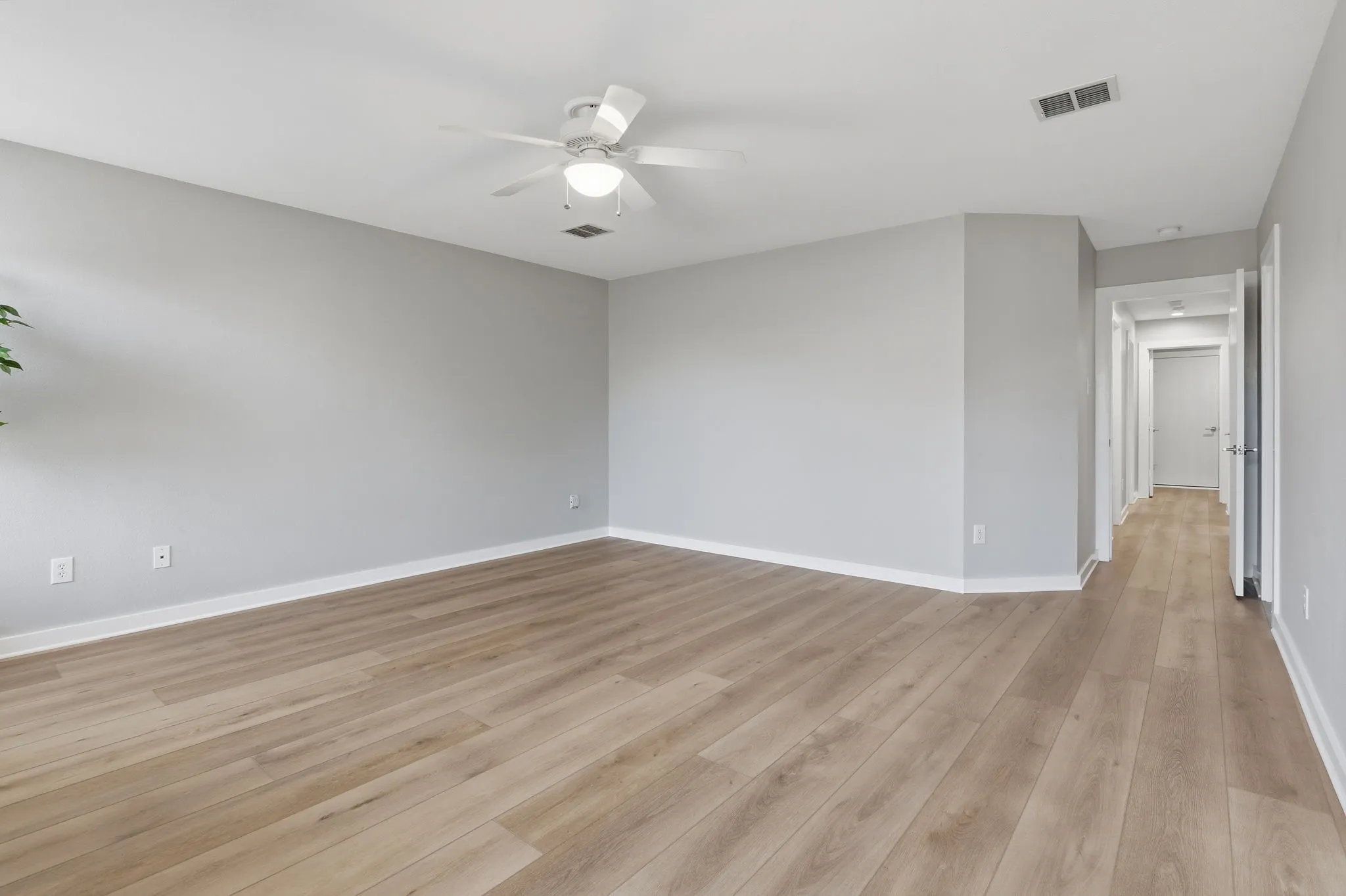 Another view highlights the generous size of the primary suite with plenty of room for a full bedroom furniture arrangement.