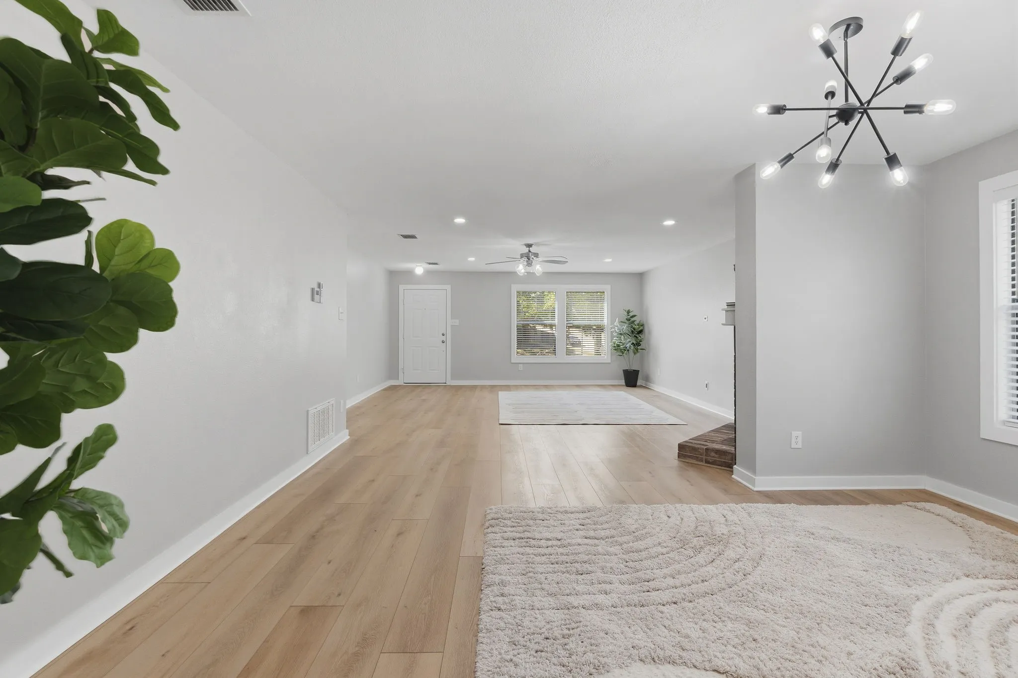 Spacious living room offers generous wall space, LVP flooring, recessed lighting and an easy connection to the rest of the home.