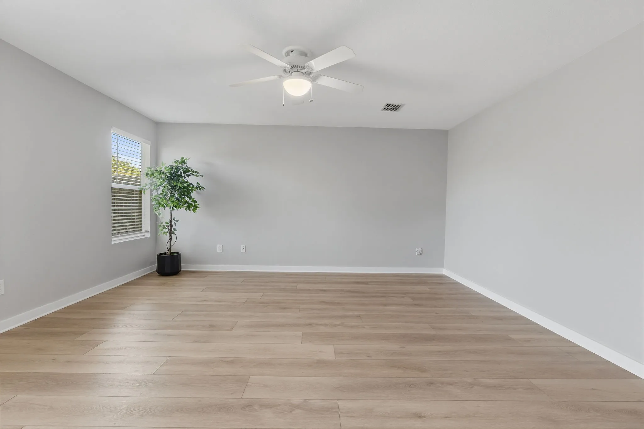 Another view highlights the generous size of the primary suite with plenty of room for a full bedroom furniture arrangement.