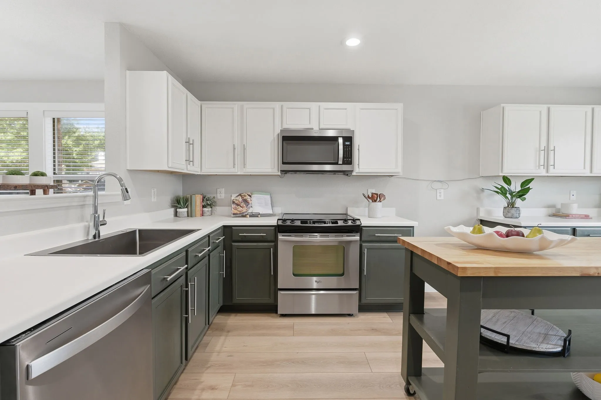 Updated kitchen offers generous counter space, stainless appliances, modern finishes and a versatile island for added prep and storage.