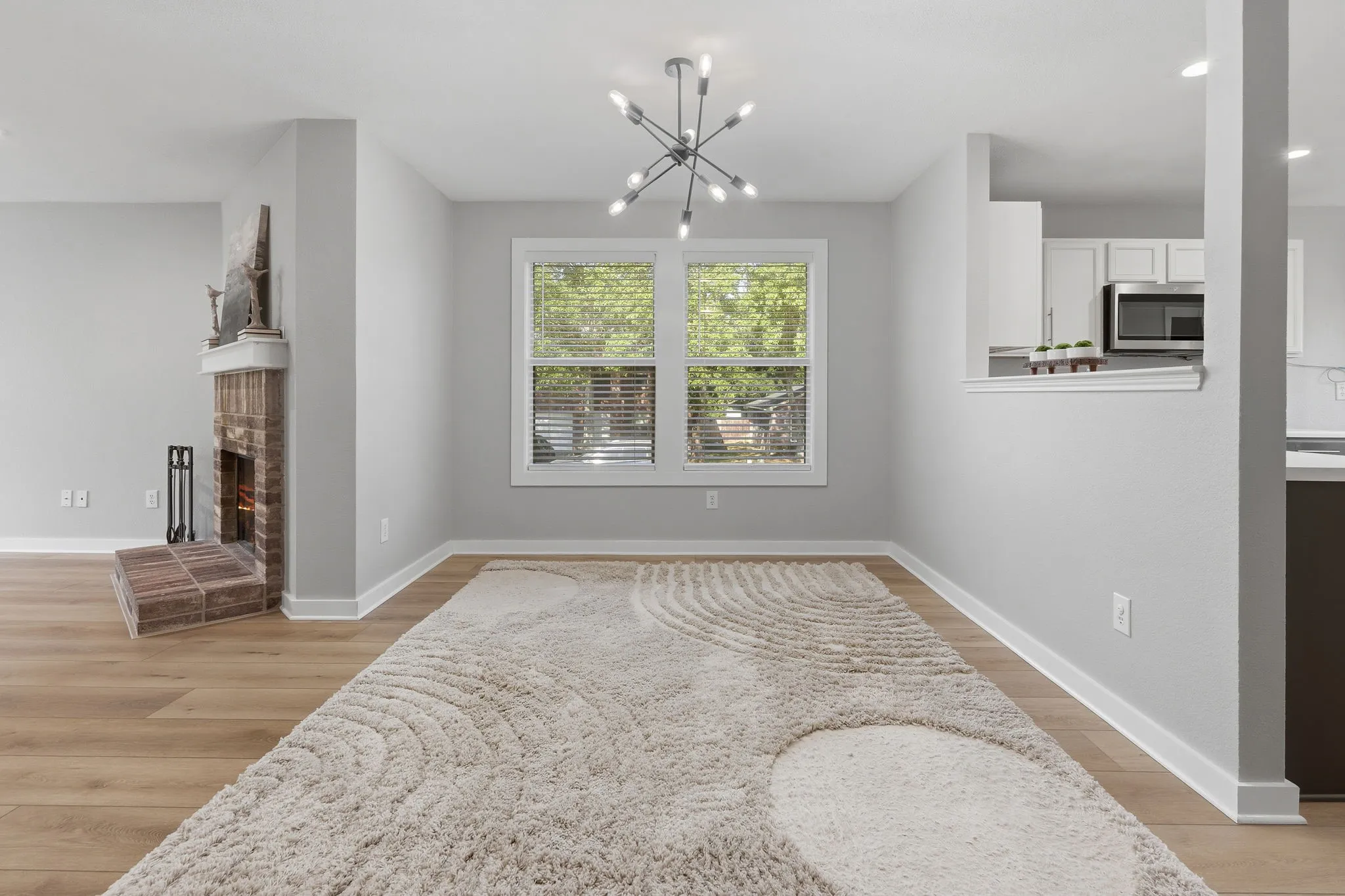 Bright dining space features updated lighting, abundant natural light and an open connection to the kitchen and living area.