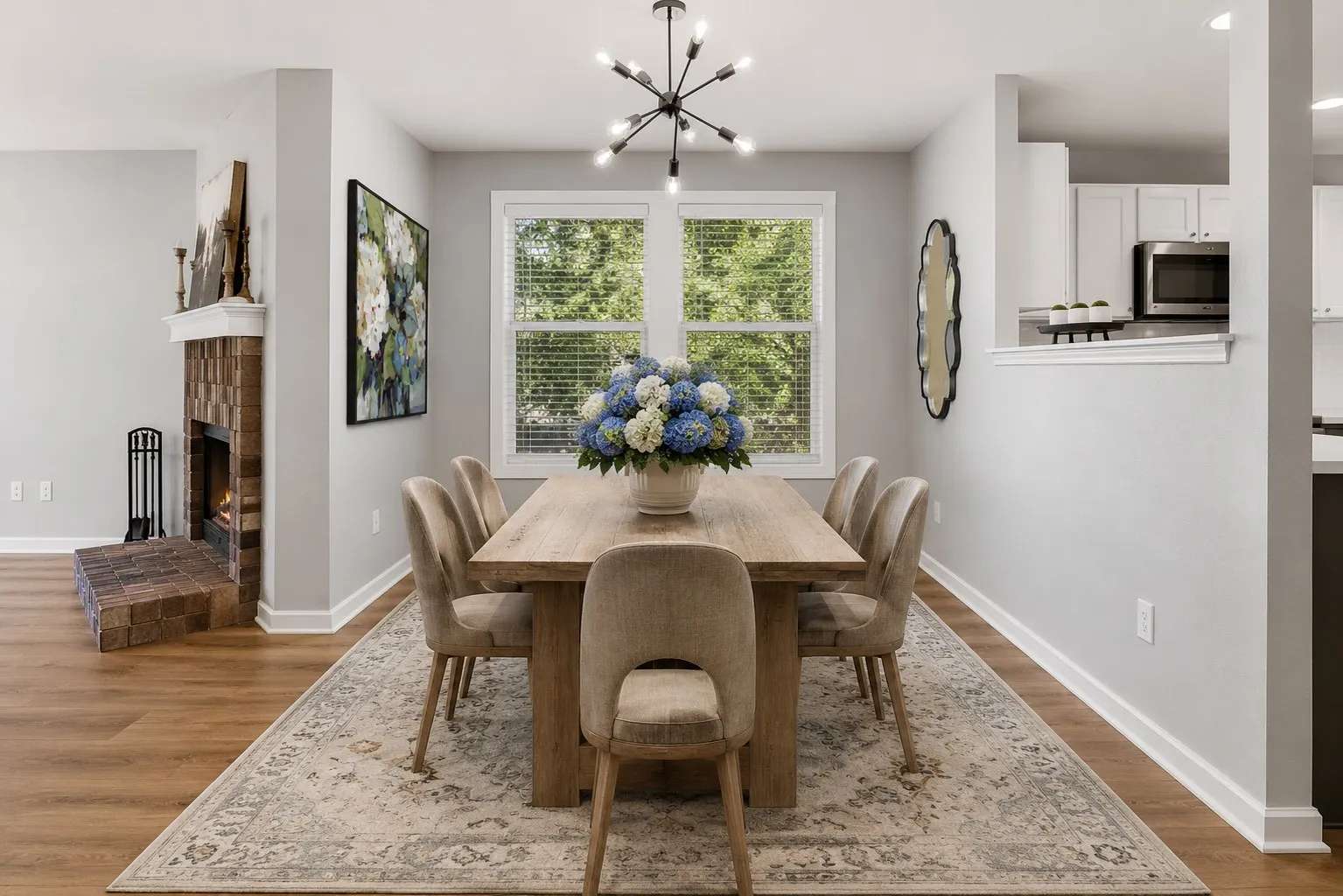 Reality Staged image highlights the dining space with abundant natural light, updated lighting and an easy connection to the kitchen and living areas.