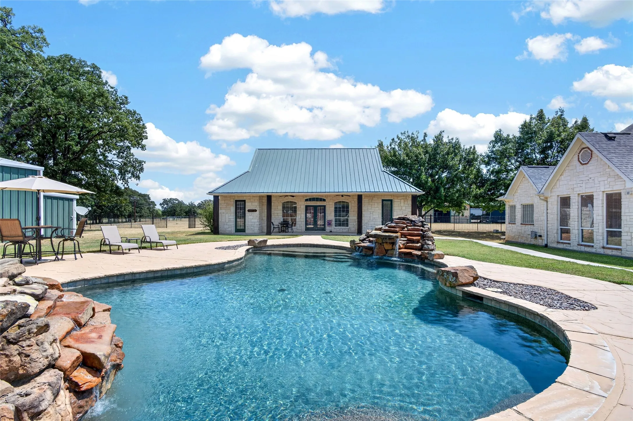 Looking at pool house and main house to the left