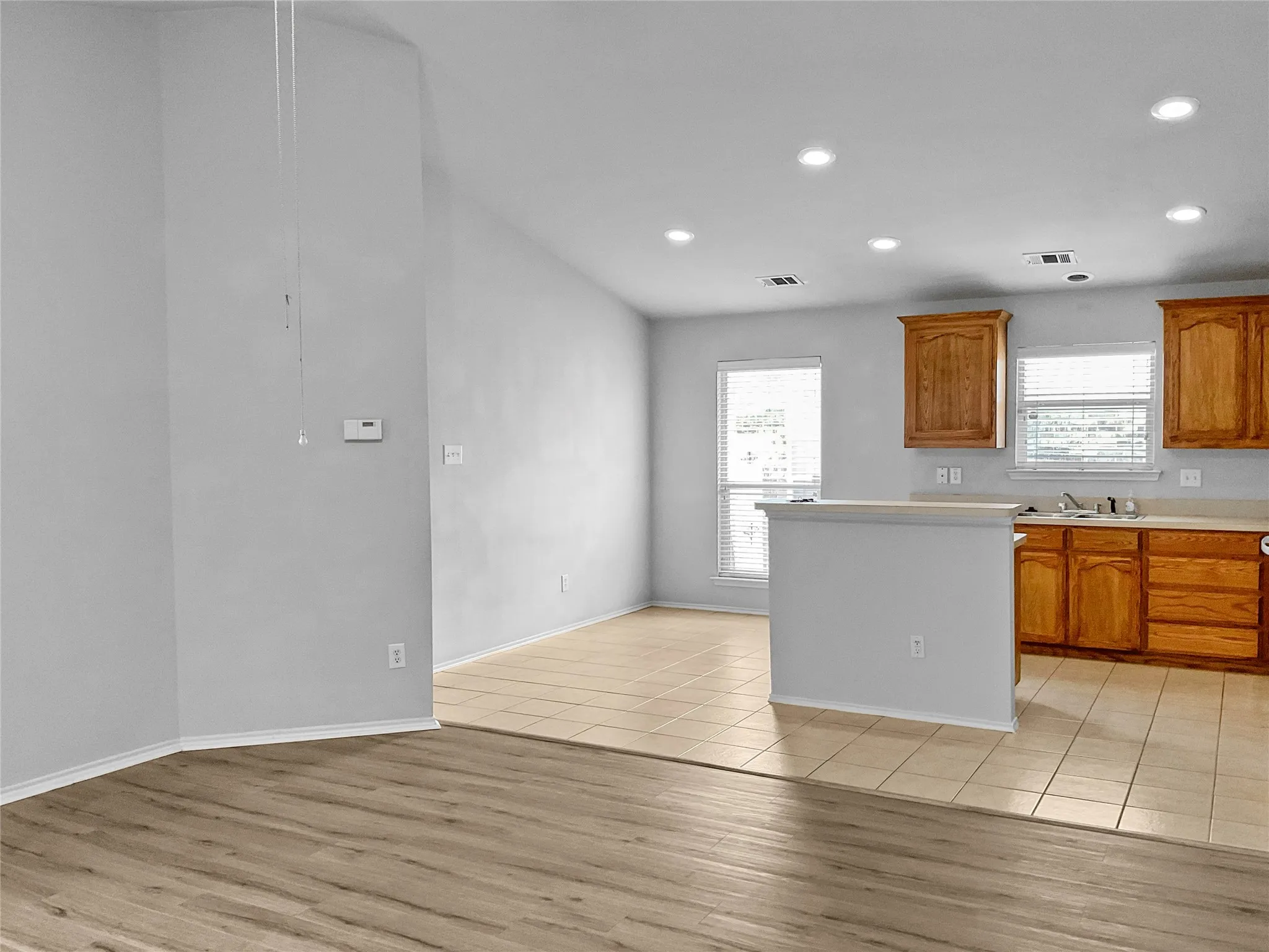 Kitchen with sink and light hardwood / wood-style flooring
