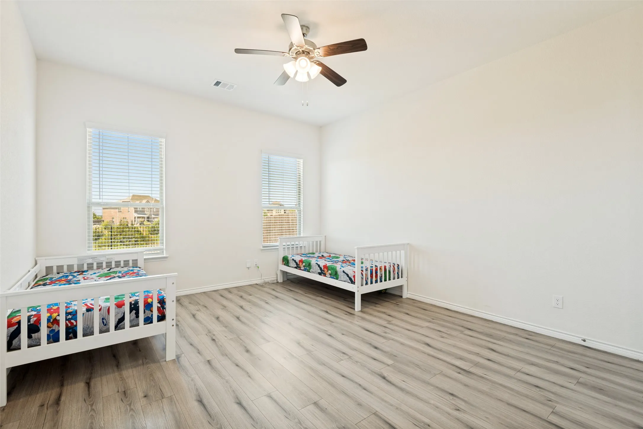 Upstairs bedroom with LVP flooring offers flexible space for a bedroom, home office, playroom or guest space.