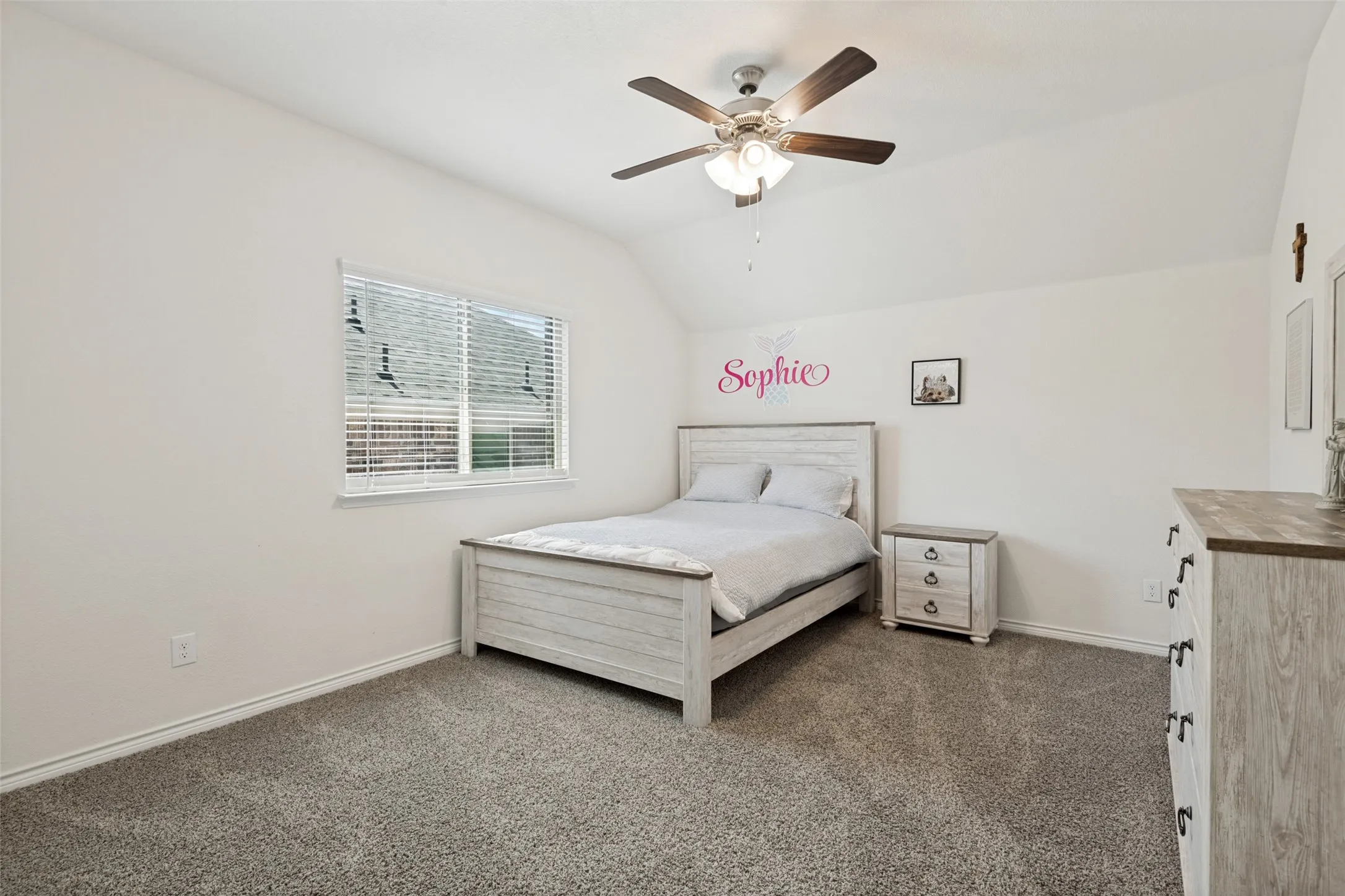 Spacious upstairs bedroom with a ceiling fan and plenty of natural light.