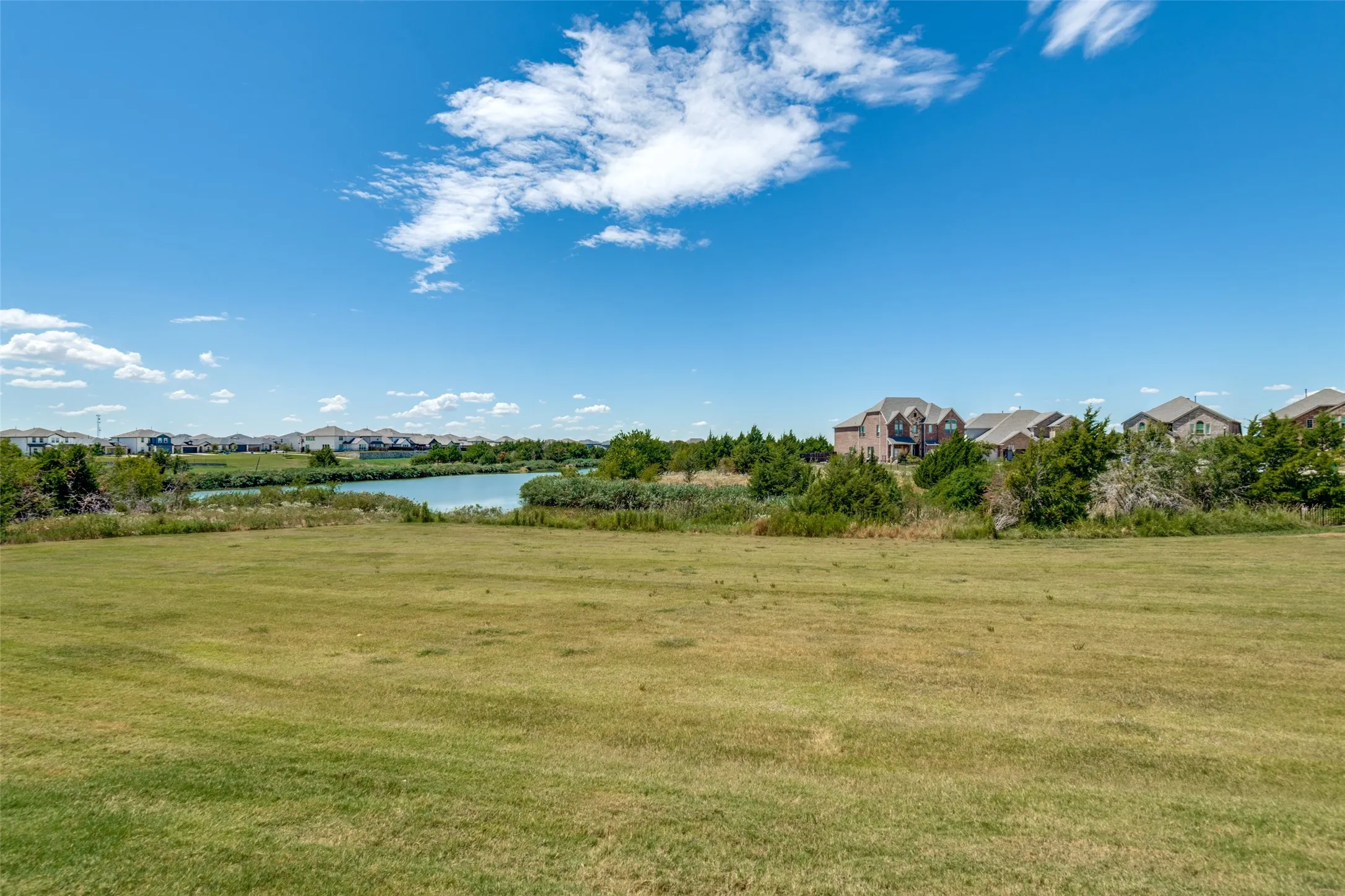 A closer look at the lake from the backyard, showcasing the peaceful water views just beyond the property.