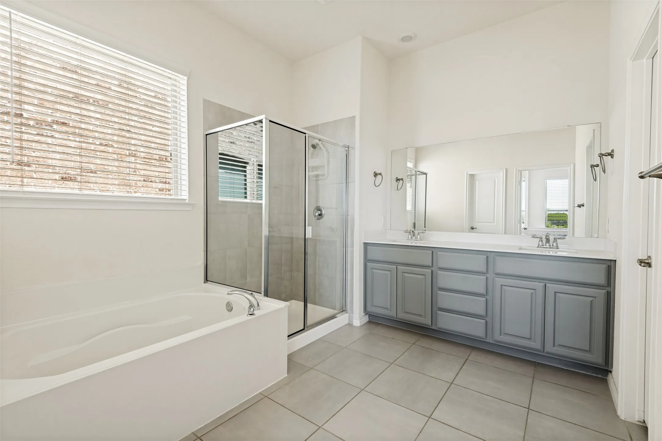Primary bath features a soaking tub and separate walk-in shower for a relaxing retreat.