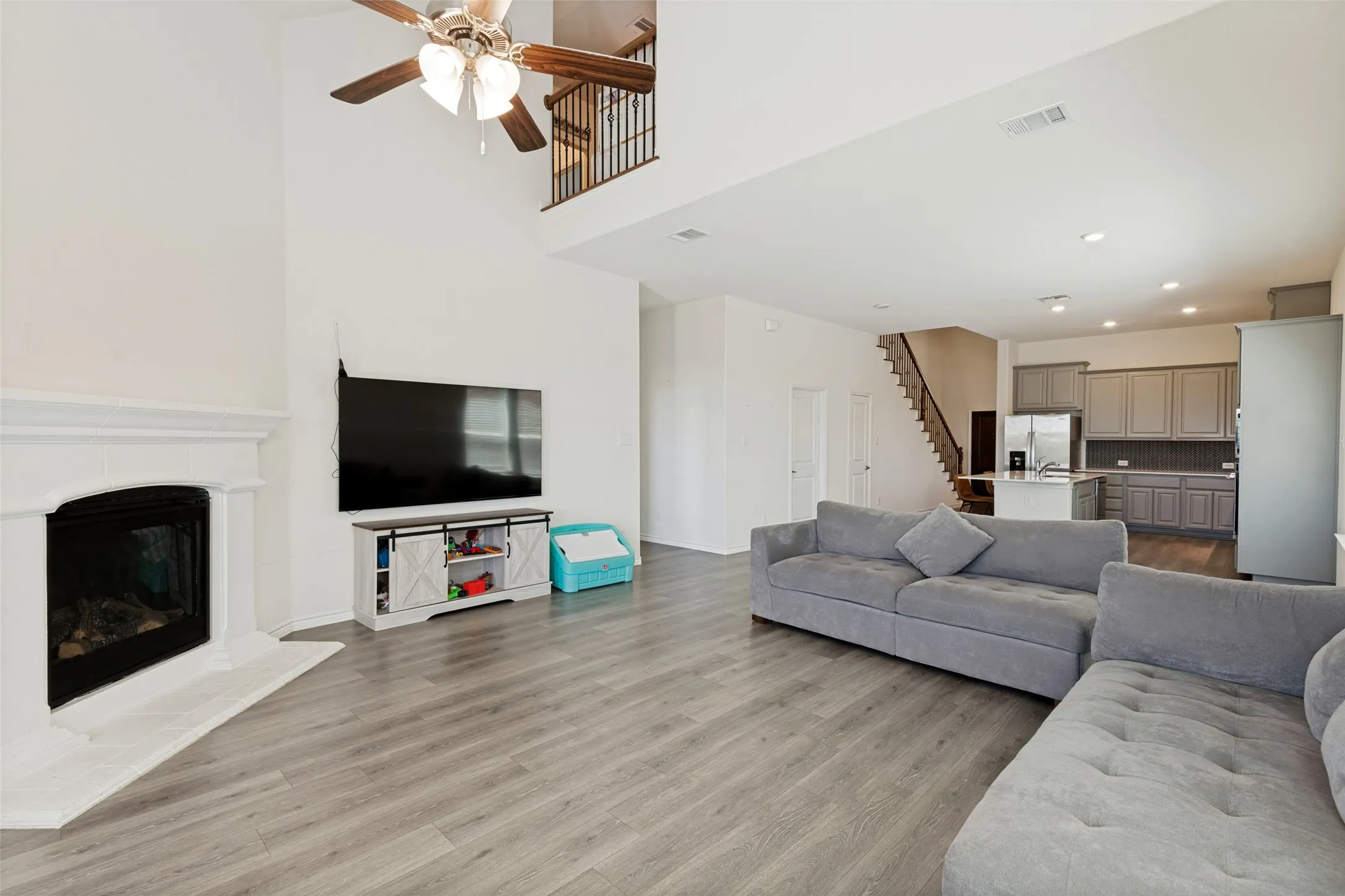 Open living area with soaring ceilings and views to the upstairs living space, adding to the home’s open and spacious feel