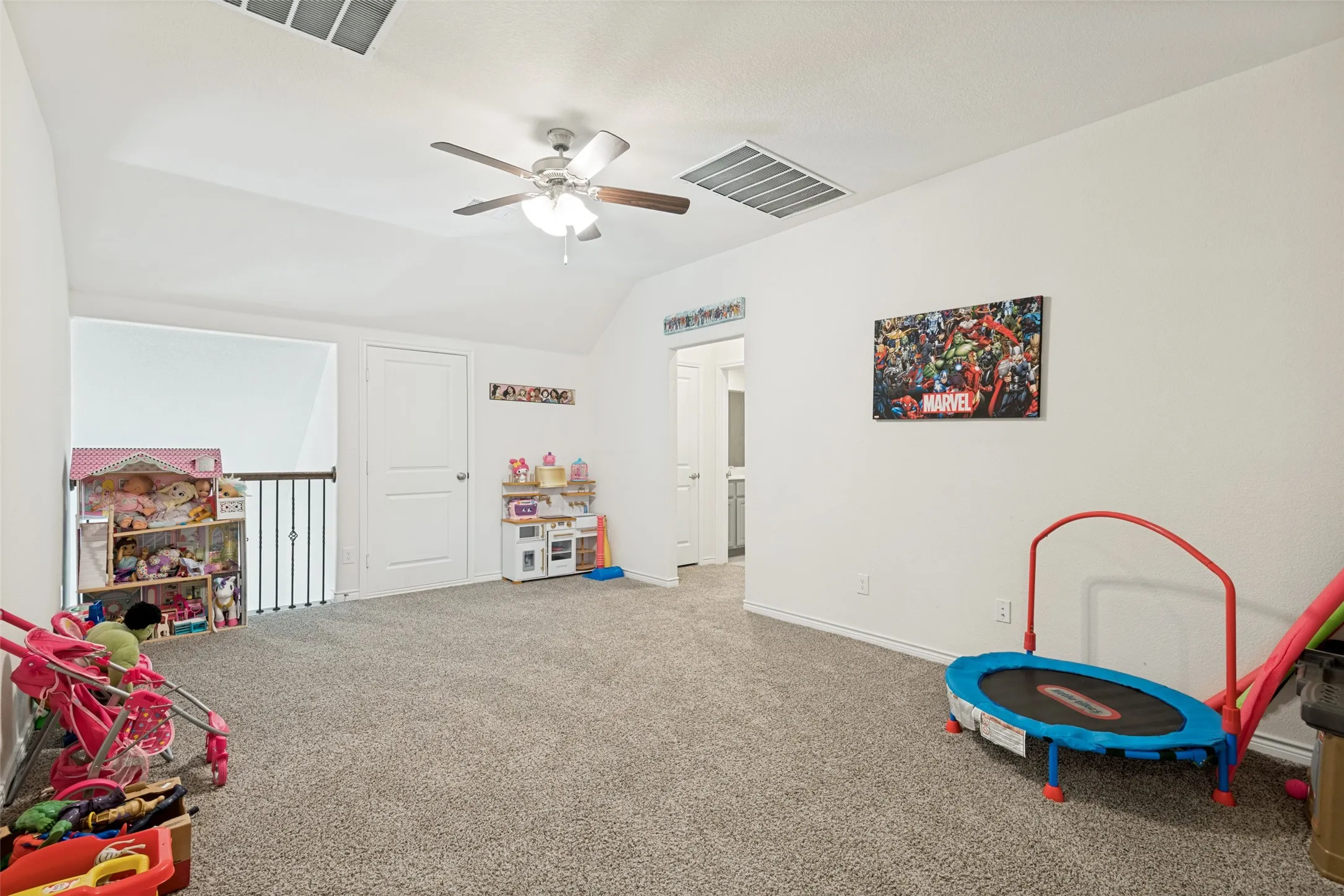 Upstairs living area is open to the space below and offers a great spot for a game room, playroom or additional lounge area.