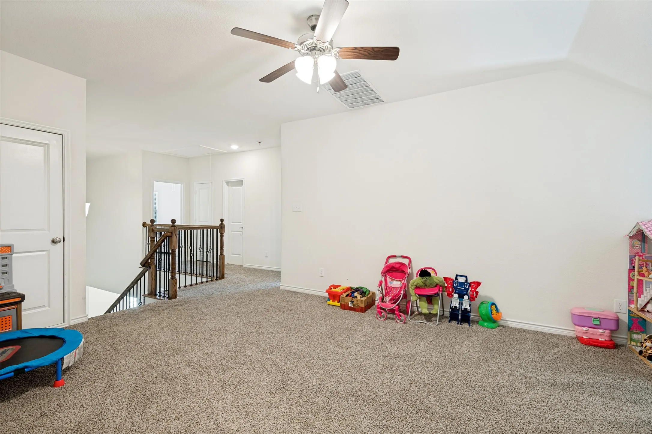 Another view of the spacious upstairs living area, currently used as a playroom with plenty of flexibility for a game room or second living space.