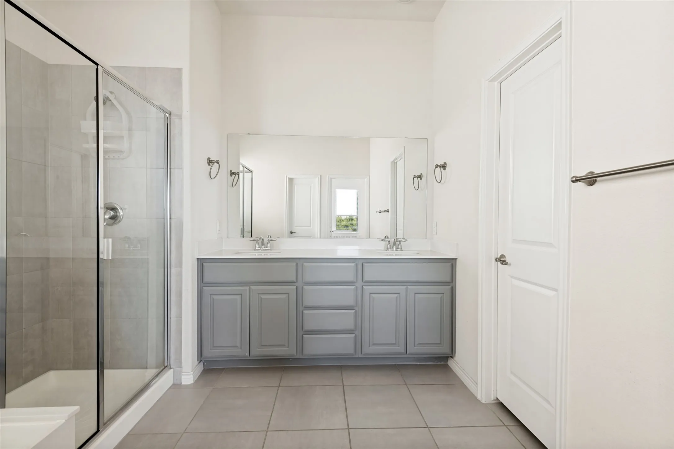 Large vanity with dual sinks offers plenty of counter space and storage.