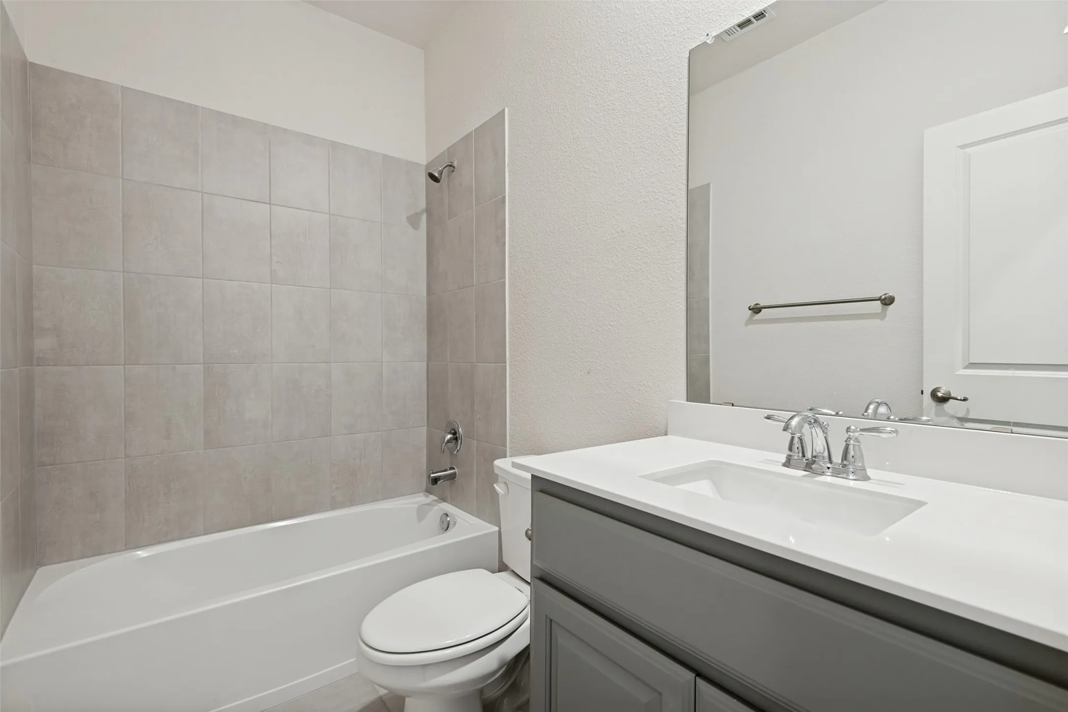 Upstairs secondary bath offers generous counter space and ample cabinet storage.