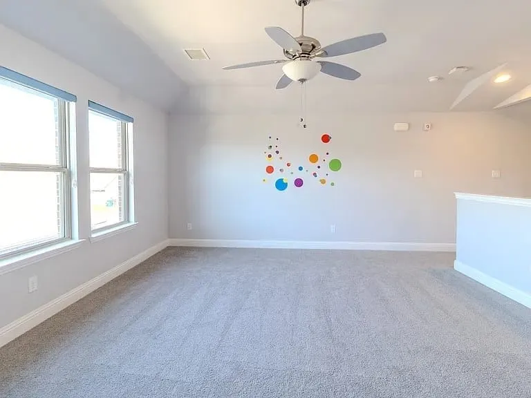 Vaulted ceiling with a ceiling fan, recessed lighting, and soft carpet flooring
