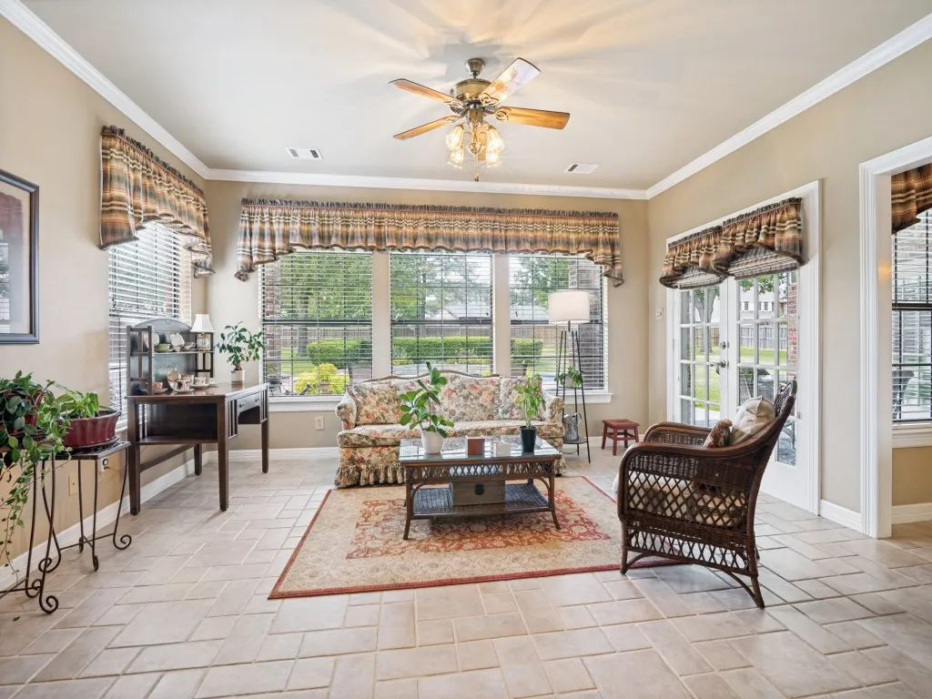 Abundant natural light in this sun room with panoramic views of the pool and back yard.