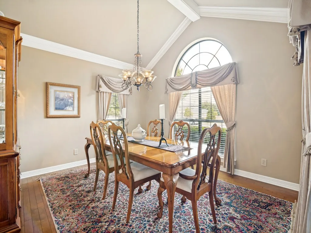 Large dining room with vaulted ceiling and extensive molding.