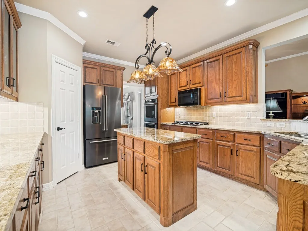 Gas cooktop, double convection oven, built-in microwave, walk-in pantry and recessed lighting are some of the additional features of the kitchen.