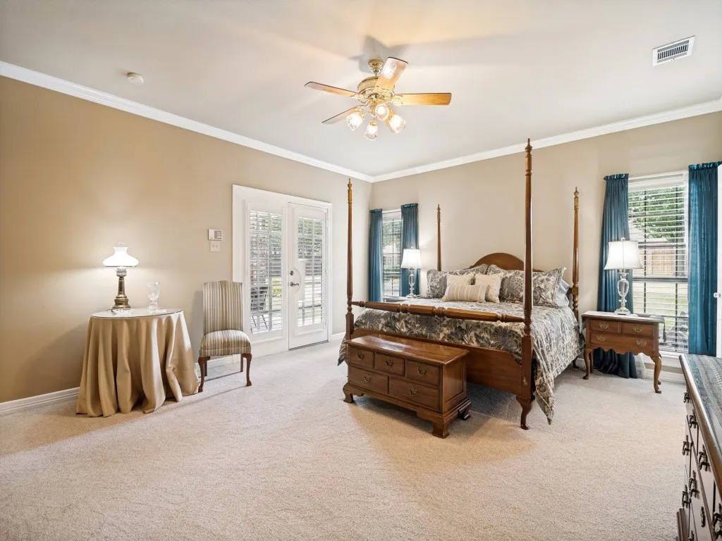 This oversized primary bedroom has access to the covered patio.