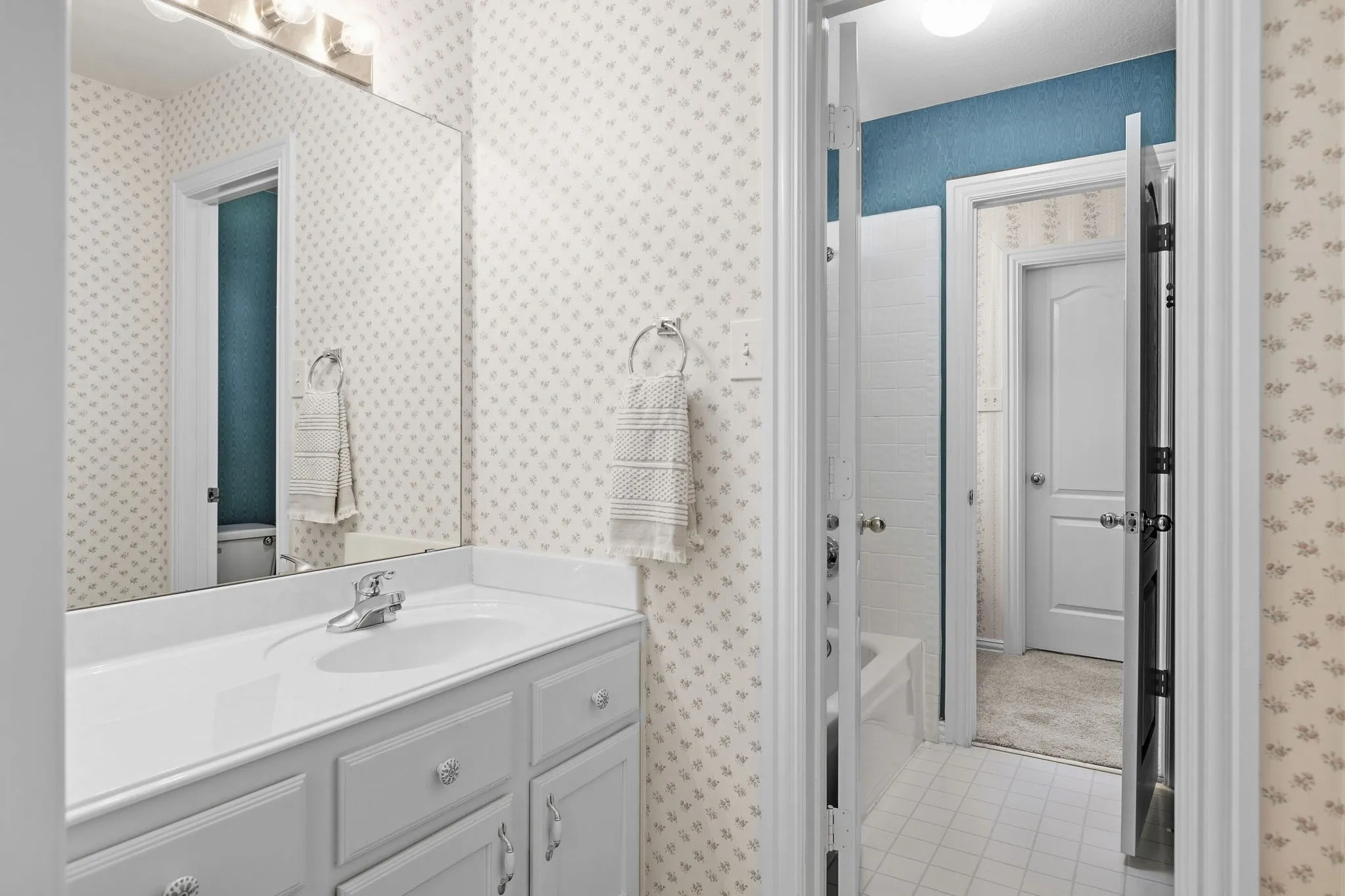 Guest Bedroom 2: Hollywood bathroom vanities in each bedroom with a shared tub/shower combo