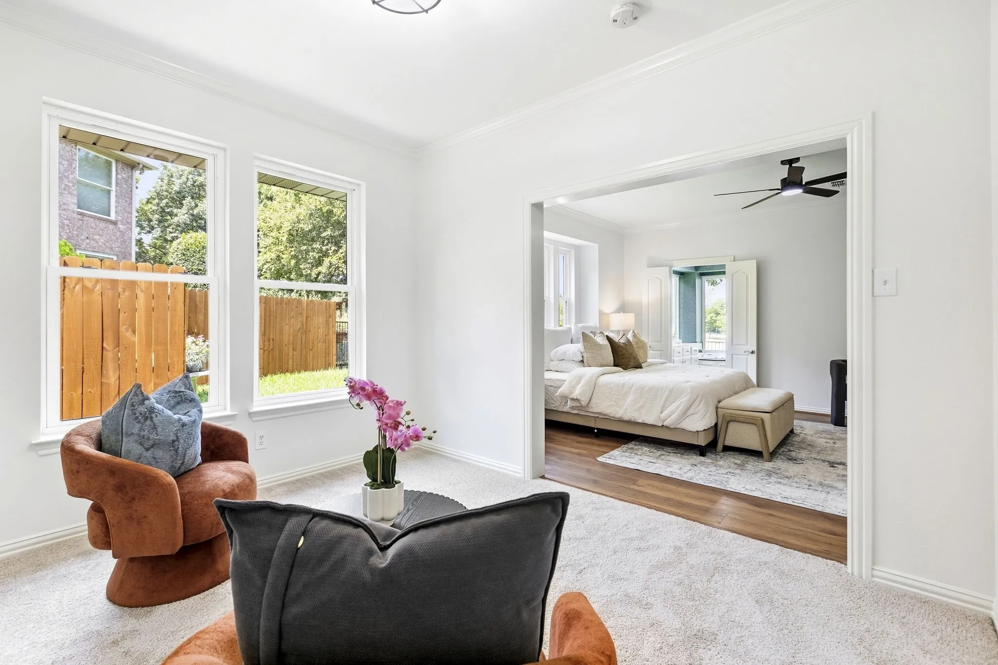 Primary Bedroom Study: Carpeted room featuring crown molding, dual windows, and new light fixture