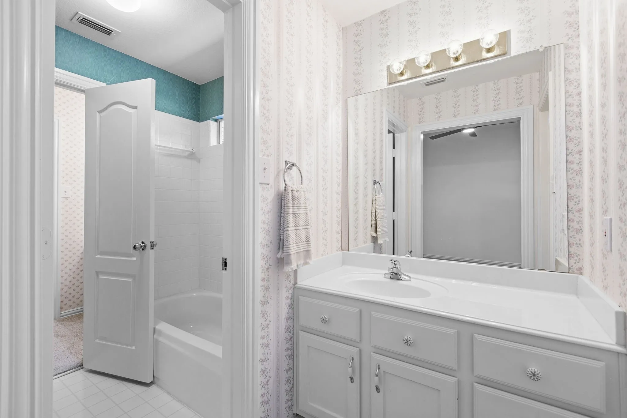 Guest Bedroom 3: Hollywood bathroom vanities in each bedroom with a shared tub/shower combo