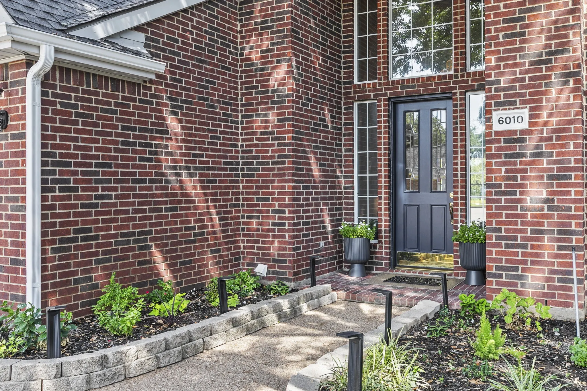 Move in Ready! New Roof Sept 2026, sewer line repaired Sept 2026, two units: HVAC 2026, HVAC 2017, both serviced Sept 2026, sprinkler system repaired, interior refreshed, new carpet, Brick exterior with a prominent arched entry, large windows, and a two-car garage