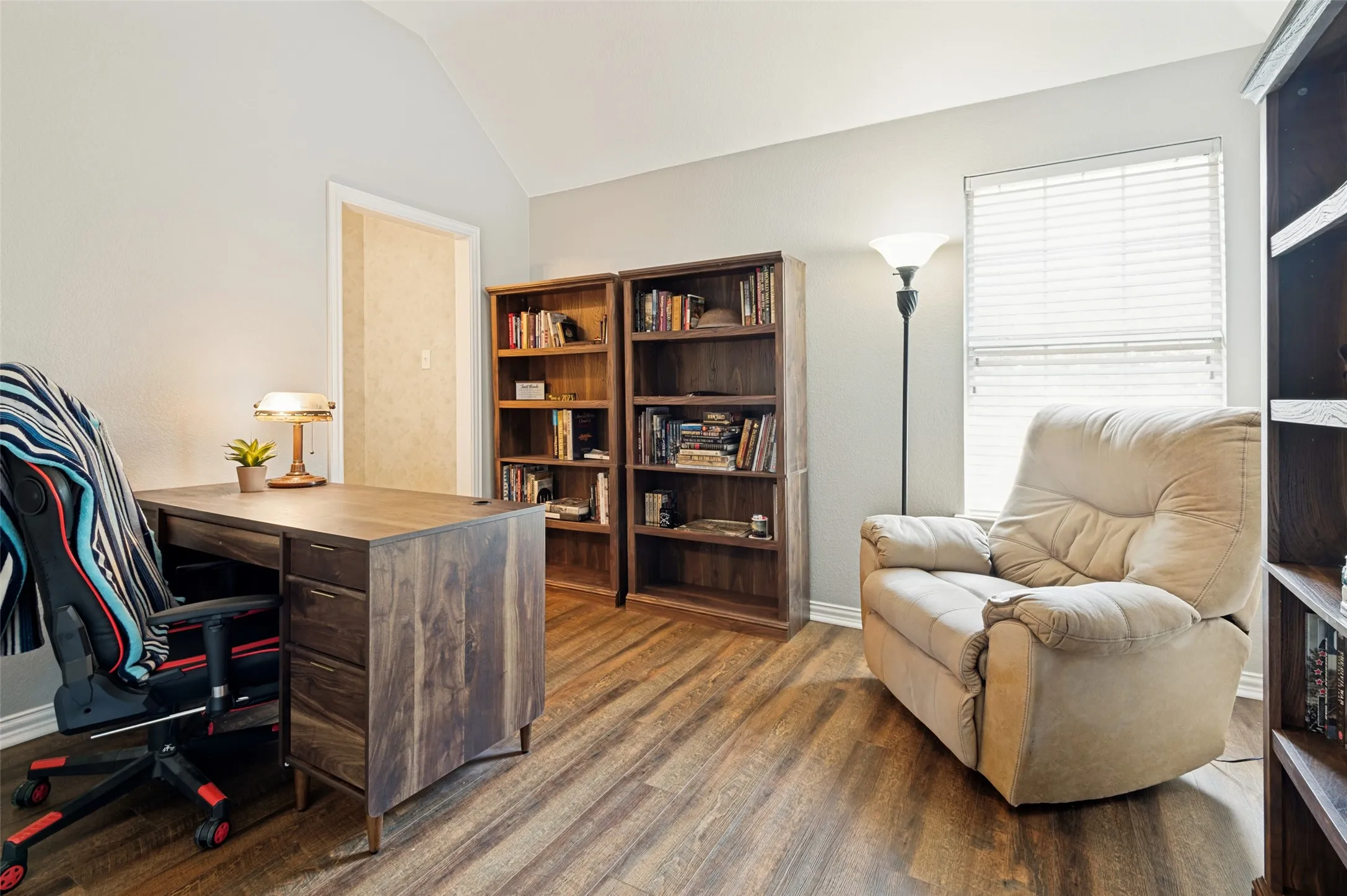 Light filled bedroom with recently installed waterproof, durable vinyl plank flooring.