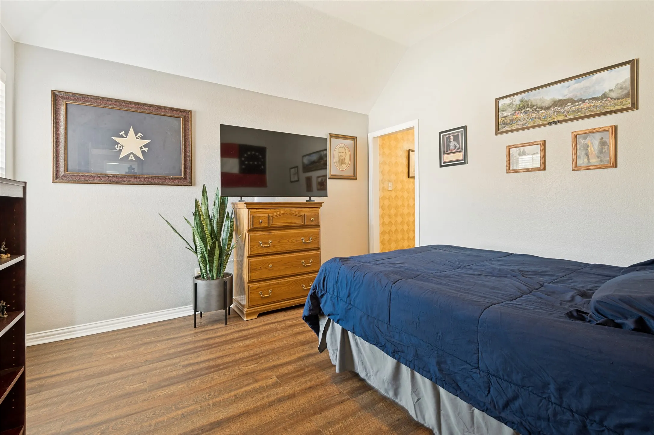 Light filled bedroom with recently installed waterproof, durable vinyl plank flooring.