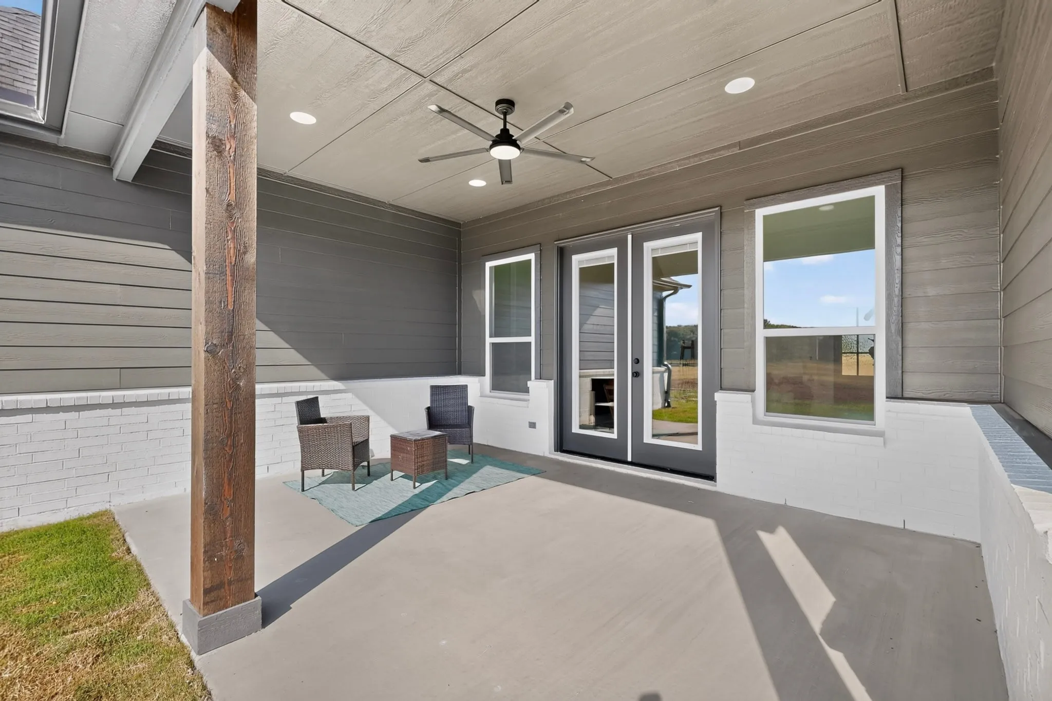 Covered patio featuring a wood support column, recessed lighting, and a ceiling fan