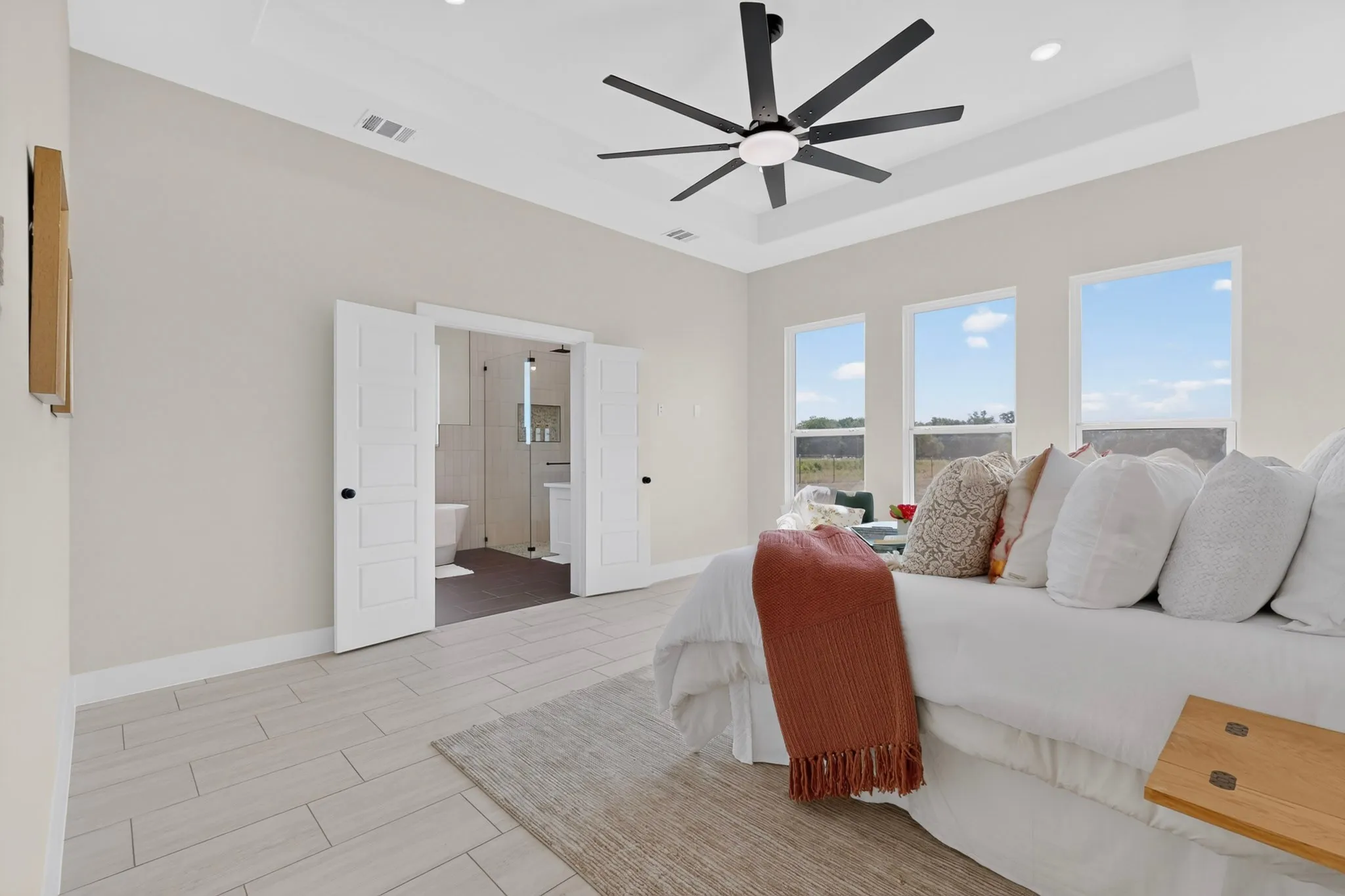Tray ceiling with recessed lighting and a contemporary ceiling fan