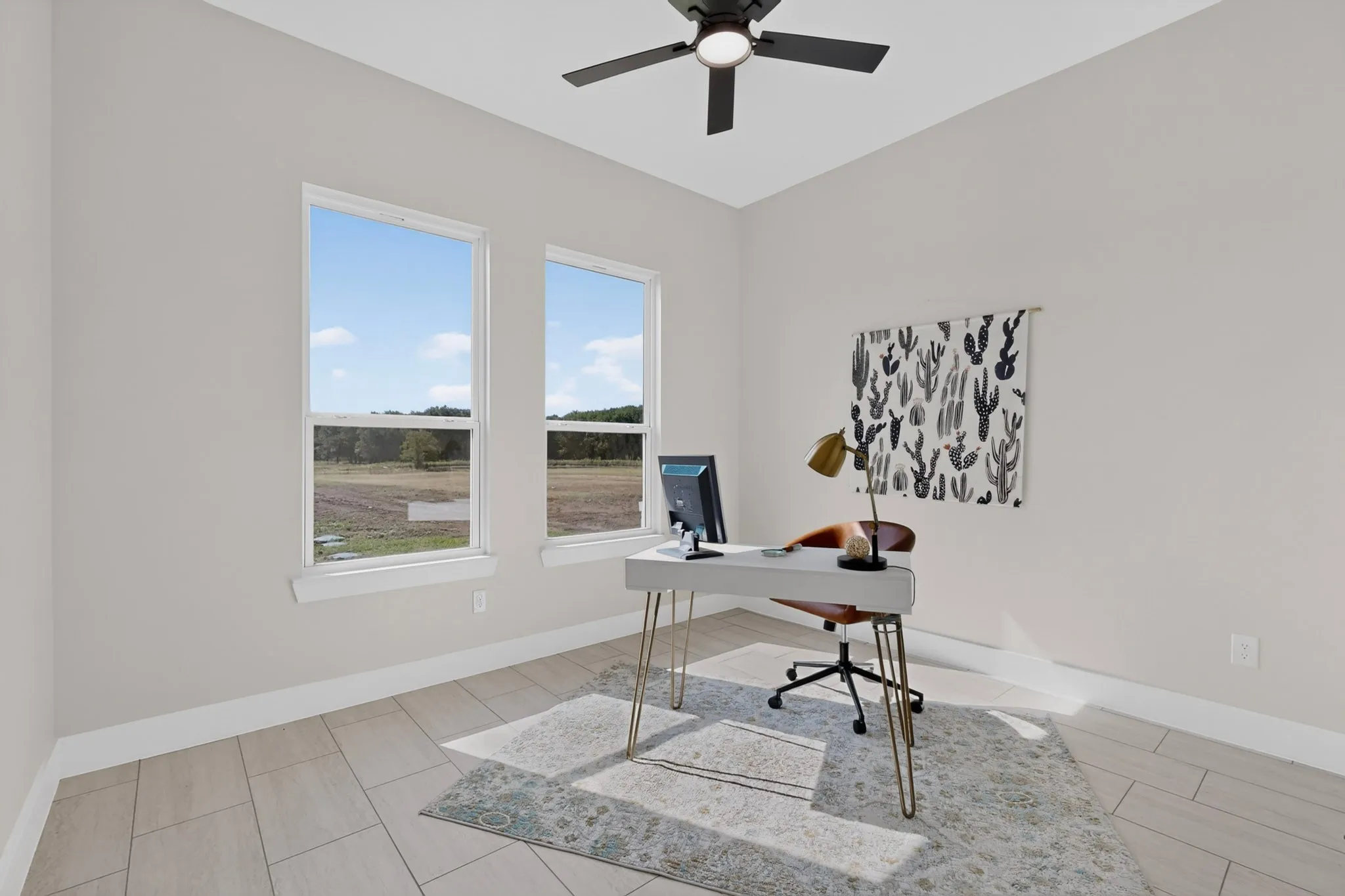 Light-toned walls complement wood-finish flooring and a ceiling fan with integrated lighting