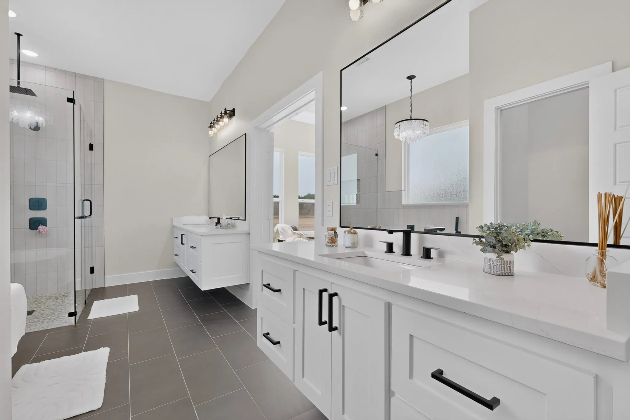 Dual floating vanities with white cabinetry and quartz countertops